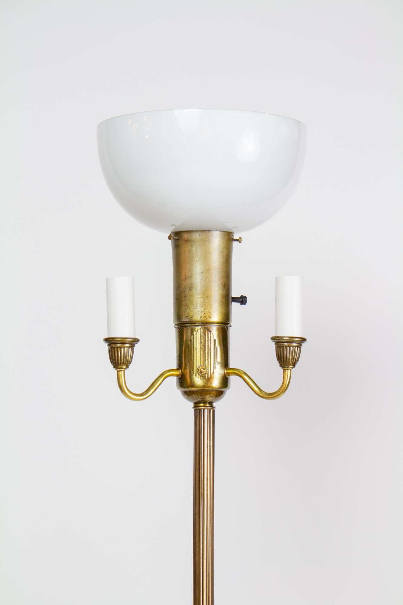Six way floor lamp, simple and traditional. Combination of brass and brass plated parts. Mogul base socket at top, with a milk glass diffuser shade for a high level of diffuse light. Three standard base candle sockets around the center for a variety