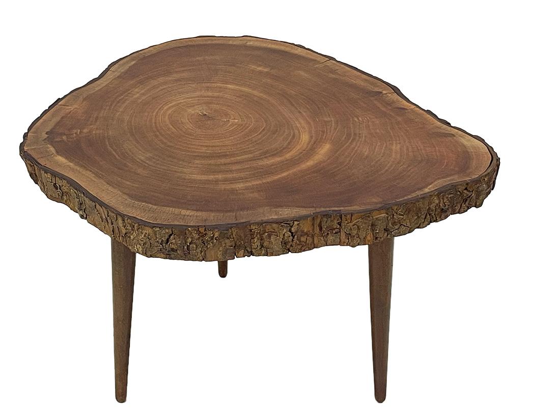 Mid 20th Century tree trunk side table

The natural walnut wooden material table top is made of a slice of timber with the original bark, raised on 3 legs. The table has a matte finish.
The measurement is 46 cm high, 62 cm wide and the depth is 64