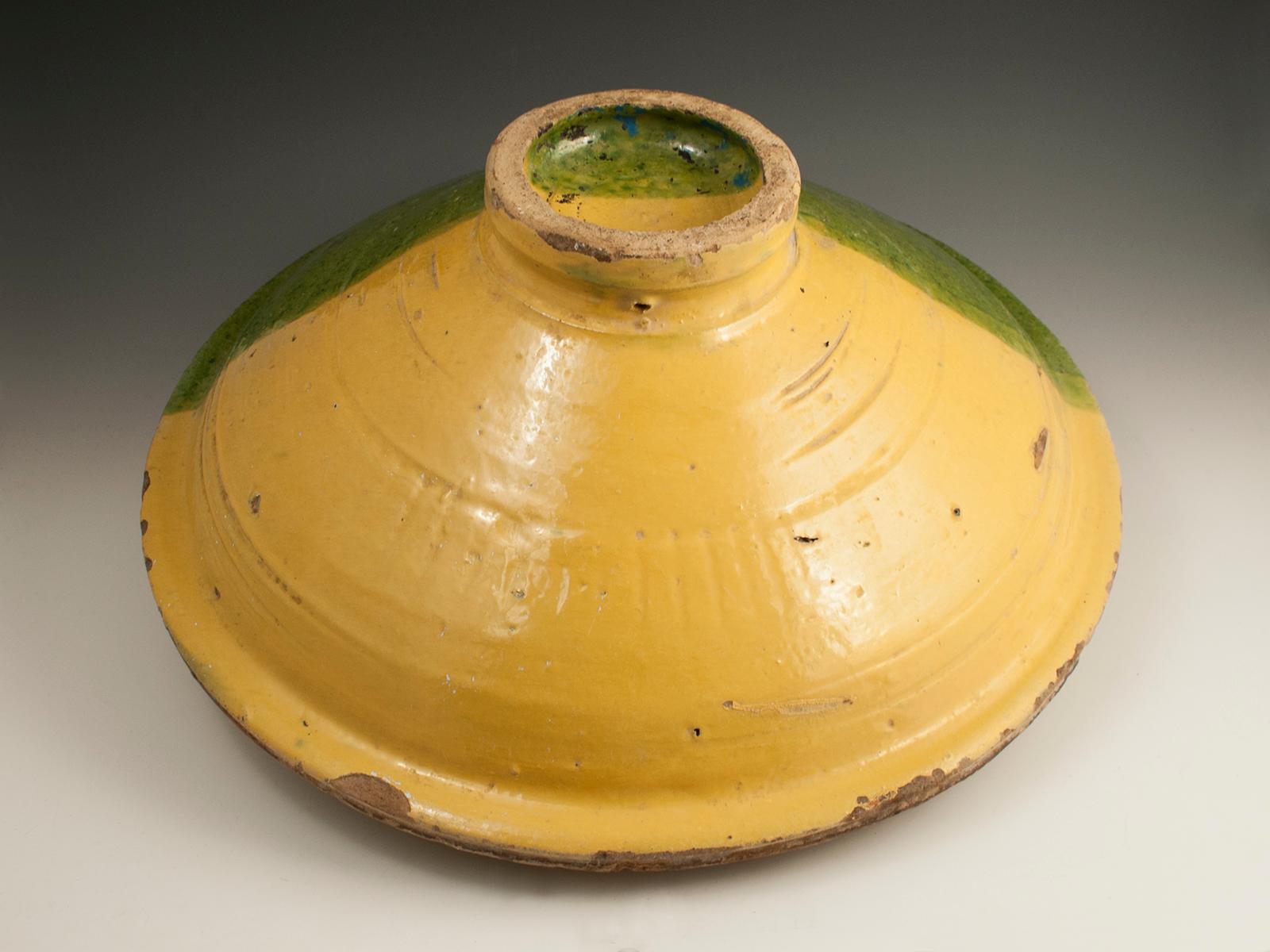 Mid-20th century tribal ceramic couscous bowl with fish motif, Tunisia

This large festive bowl, chqâla, was made in Nabeul, Tunisia. These were used at family dinners, often containing the couscous. It is said that the fish motif and the