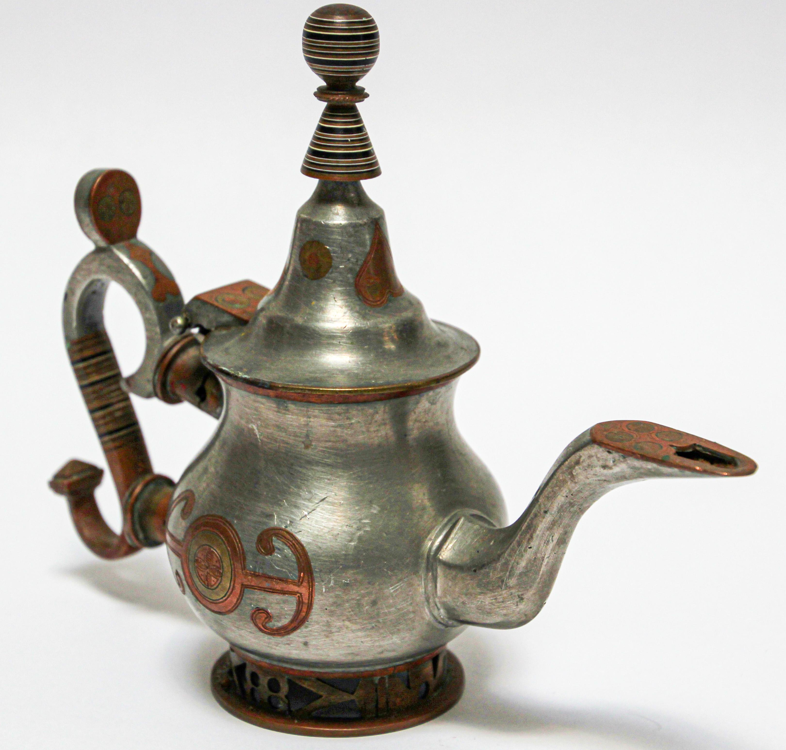 Mid-20th century Tuareg teapot from Mauritania, Africa, Western Sahara.
Handcrafted of pewter, copper and brass decorations.
The Tuareg people inhabit a large area, covering almost all the middle and western Sahara and the north-central
