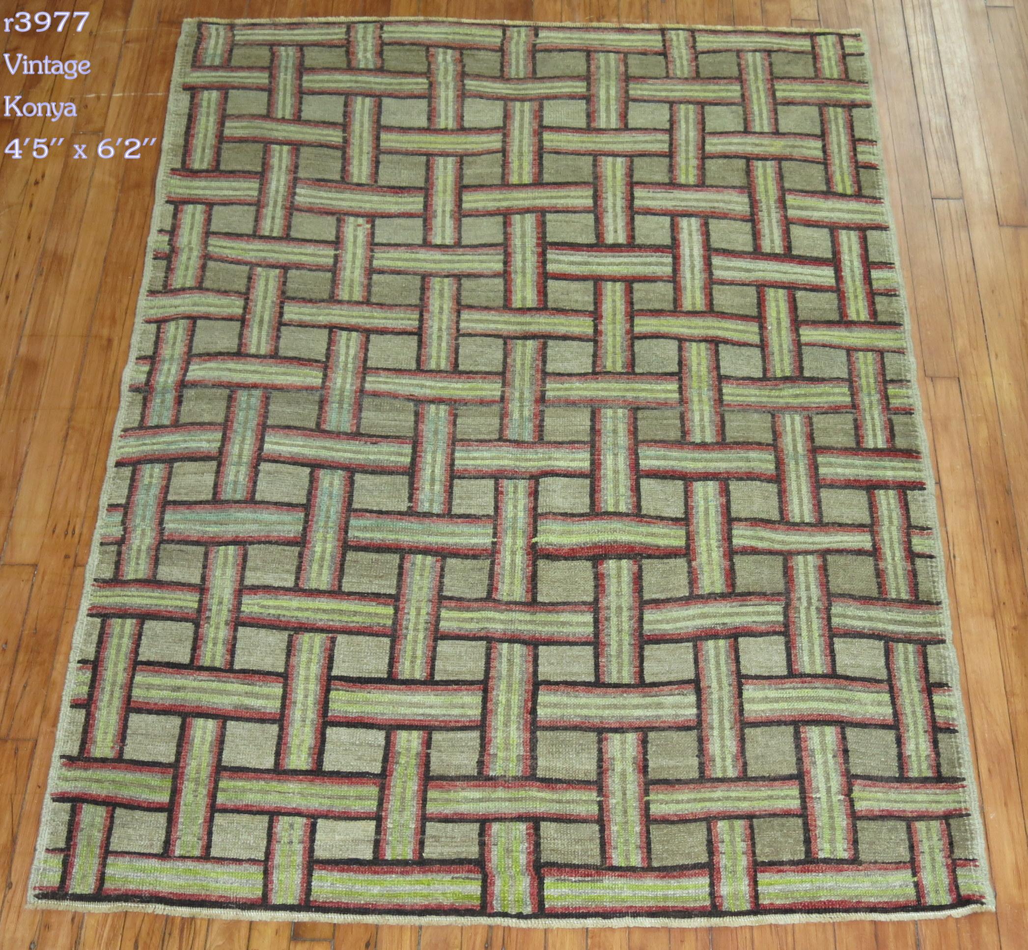 Vintage Turkish rug derived from a pattern derived from 20th century American hooked rugs. The field is an oatmeal brown color outlined in red soft green and darr brown accents wool on cotton

circa mid-20th century, measures: 4'5