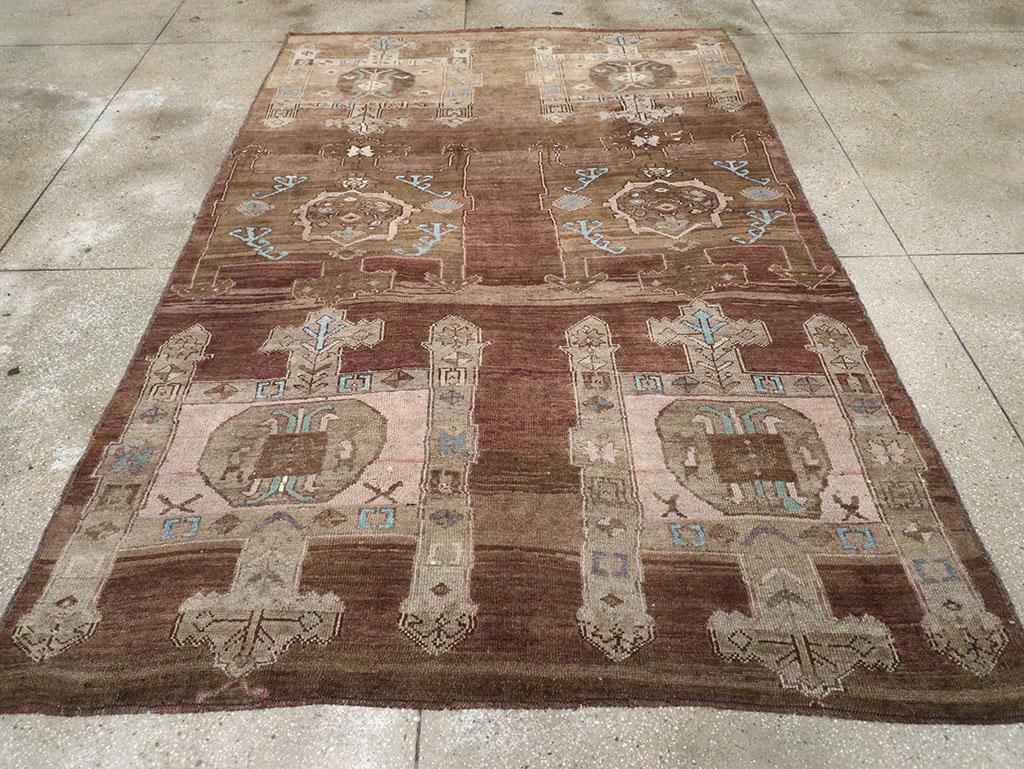 A vintage Turkish Anatolian accent carpet handmade during the Mid-20th century.

Measures: 6' 10