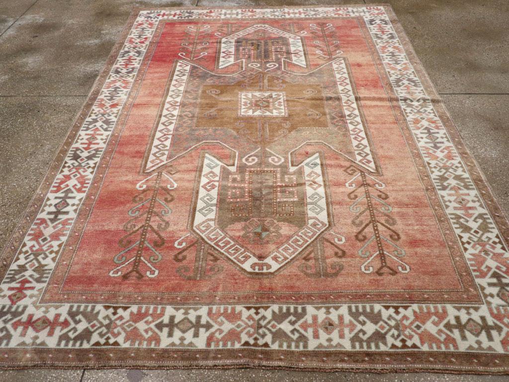A vintage Turkish Anatolian accent carpet handmade during the Mid-20th century.

Measures: 7' 0