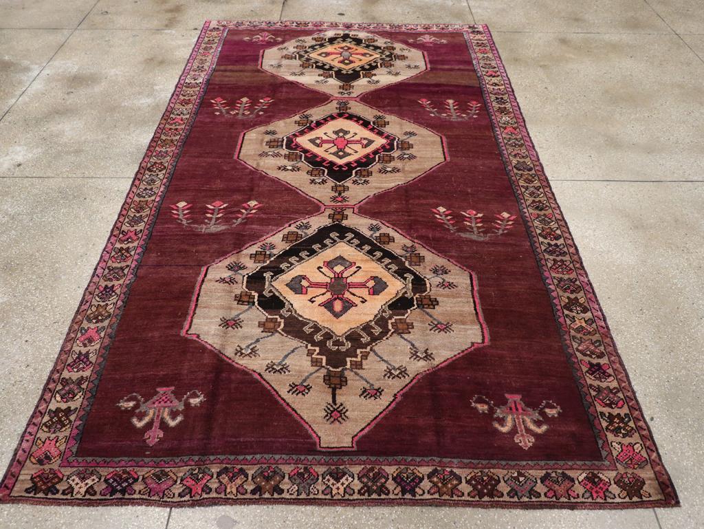 A vintage Turkish Anatolian gallery carpet handmade during the Mid-20th century.

Measures: 6' 9