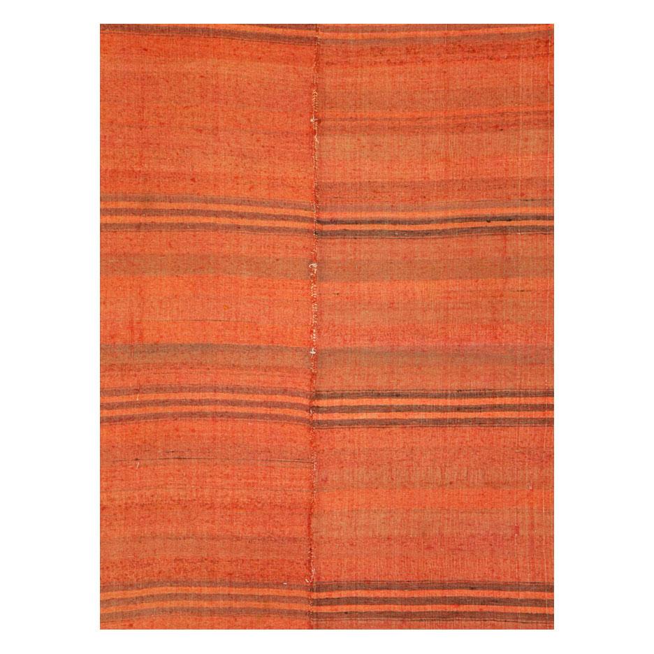 A vintage Turkish flat-weave Kilim small room size carpet handmade during the mid-20th century in shades of red orange.

Measures: 7' 10