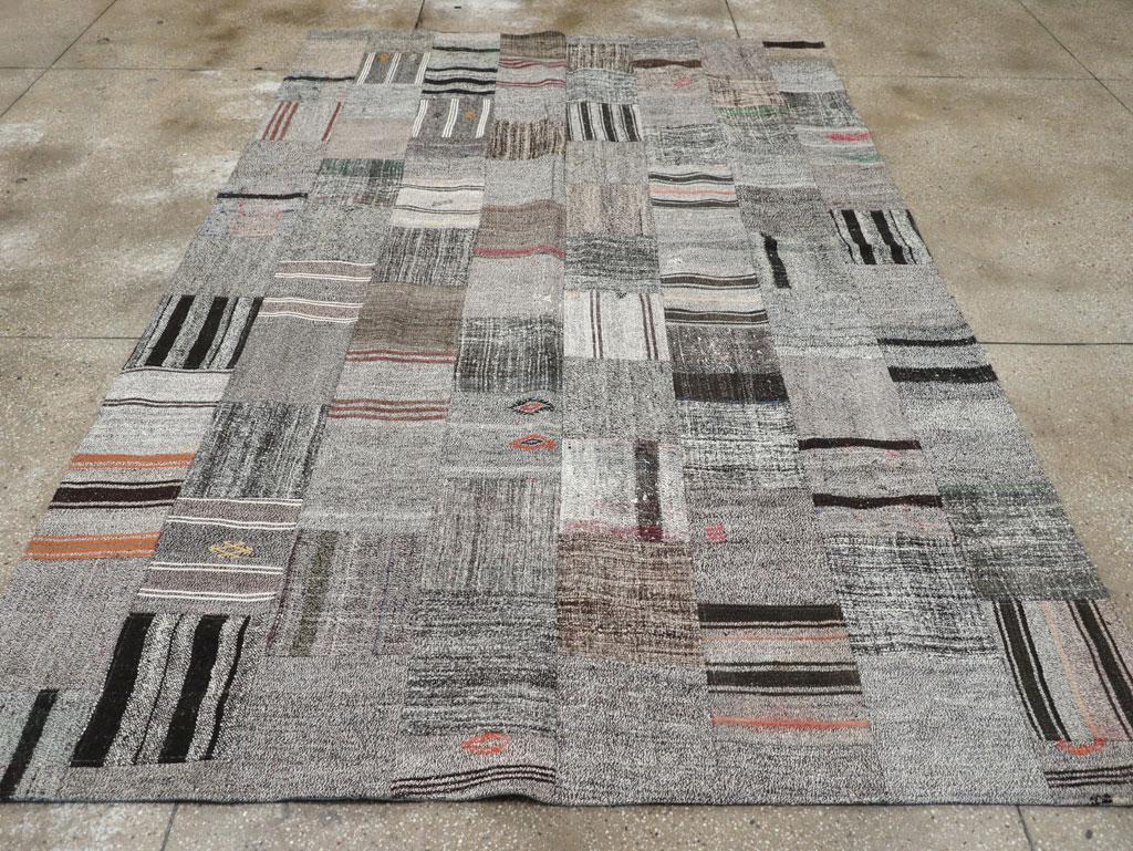 This Mid-20th century Turkish Flatweave Kilim rug, measuring 7' 5