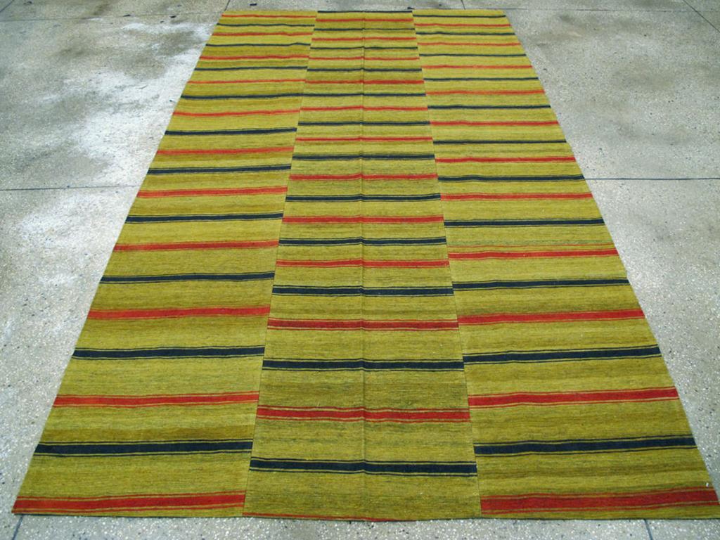 This Mid-20th century Turkish Flatweave Kilim rug, measuring 5' 7