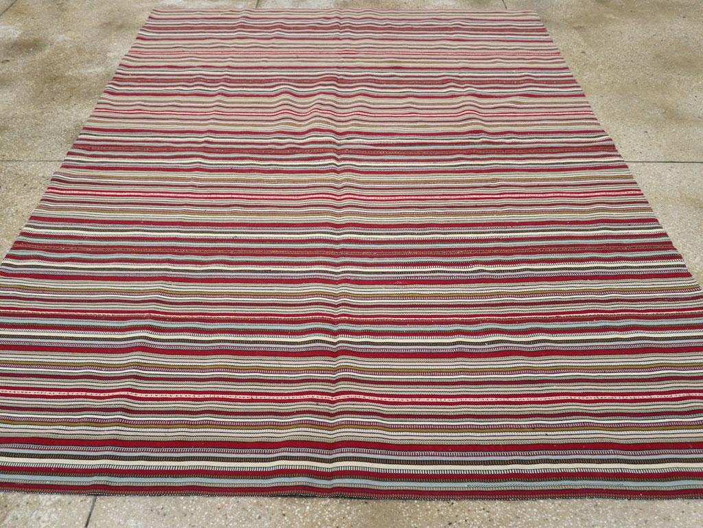 This Mid-20th century Turkish flatweave kilim rug, measuring 7' 2