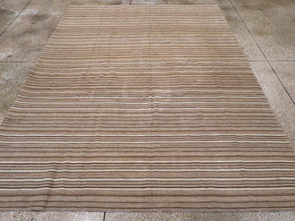 This Mid-20th century Turkish Flatweave Kilim rug, measuring 6' 10
