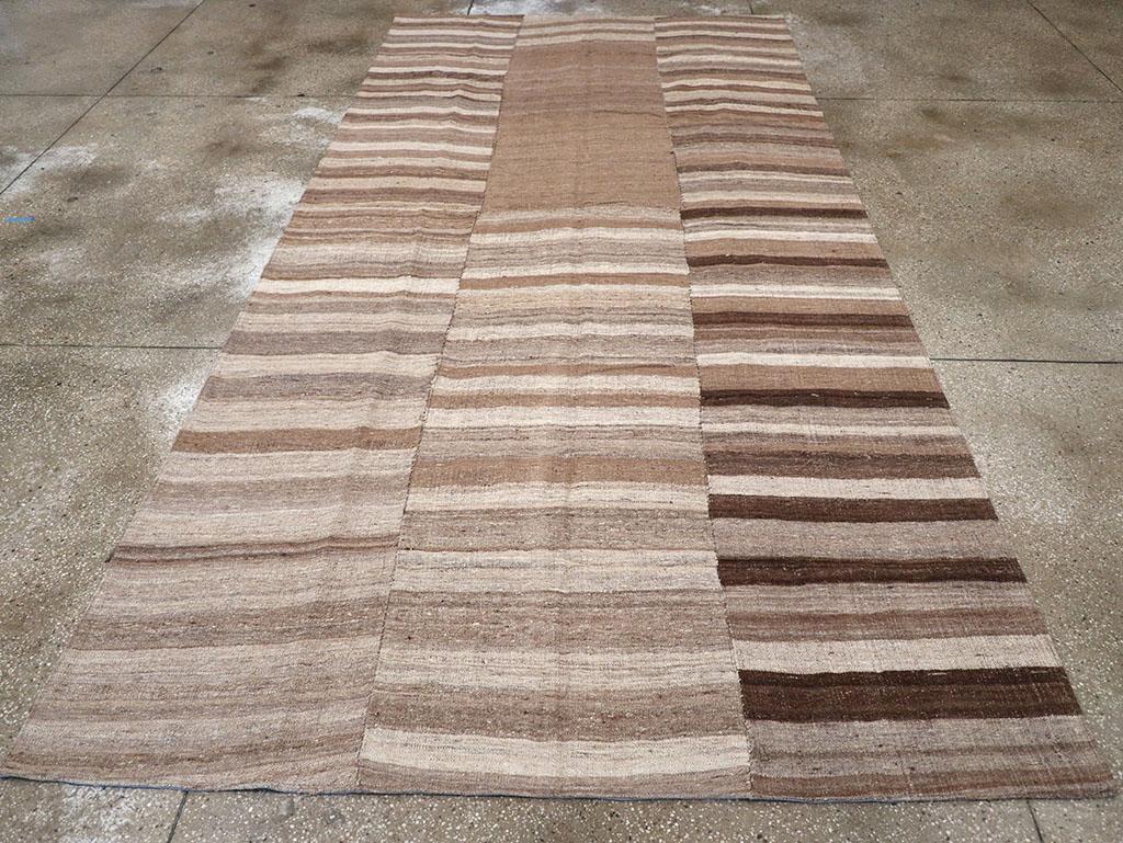 This mid-20th century Turkish flatweave kilim rug, measuring 6' 4