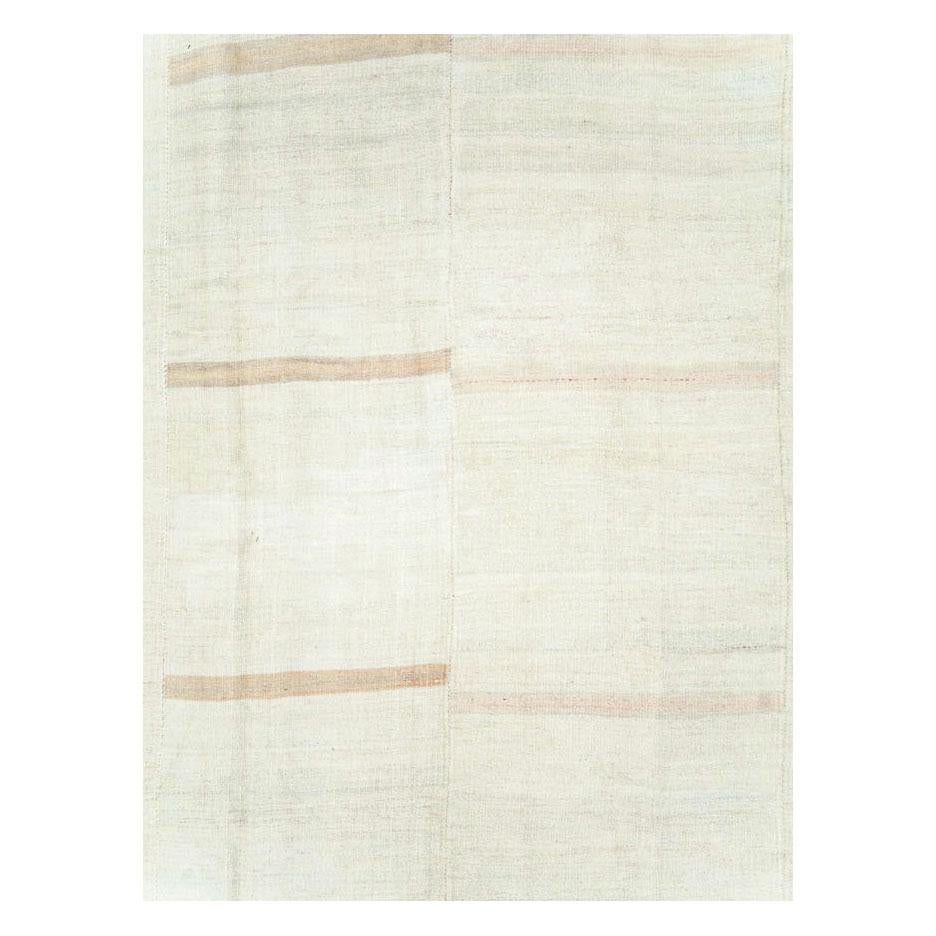 A vintage Turkish flat-weave Kilim large room size carpet handmade during the mid-20th century with a minimalistic design in cream white.

Measures: 11' 10