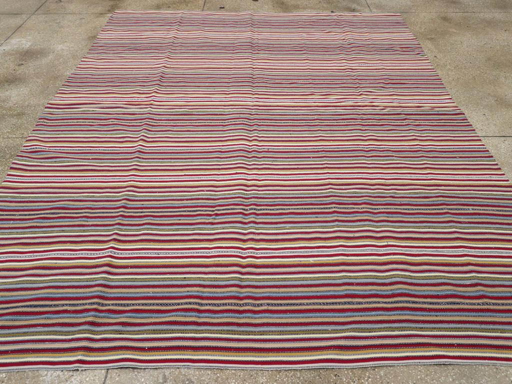 This Mid-20th century Turkish flatweave kilim rug, measuring 8' 0