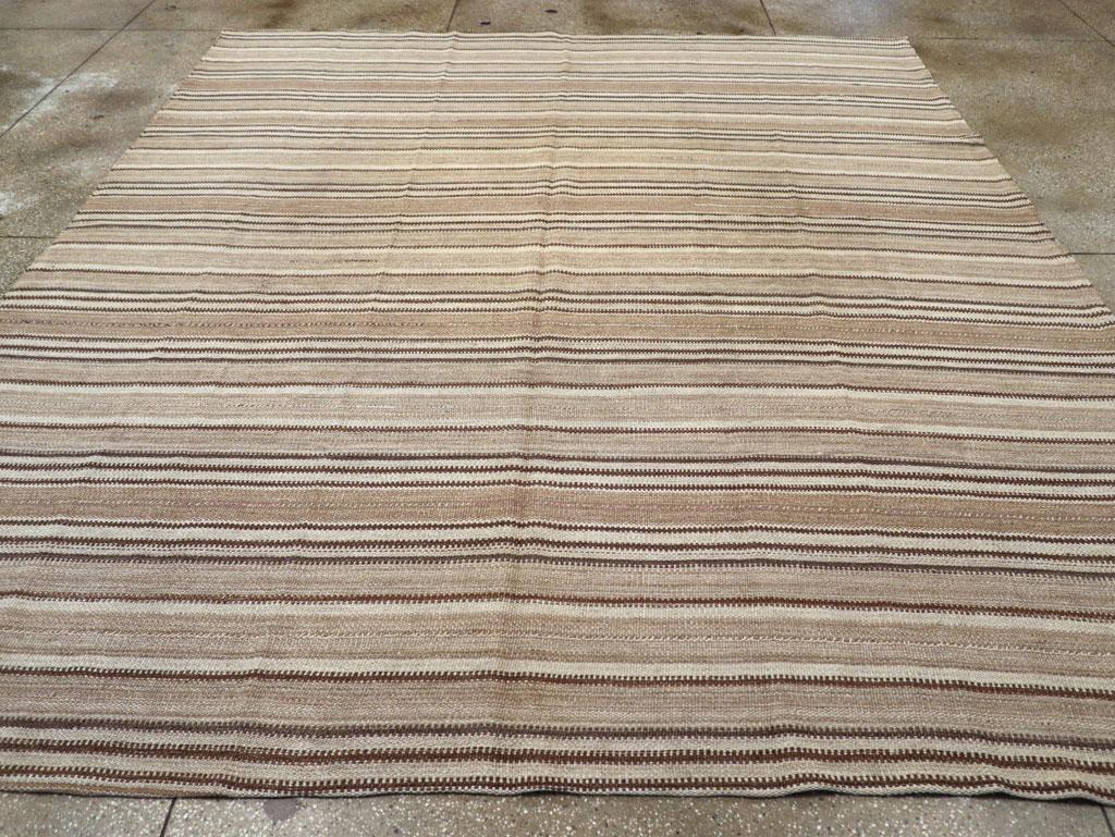 This Mid-20th century Turkish Flatweave Kilim rug, measuring 9' 8