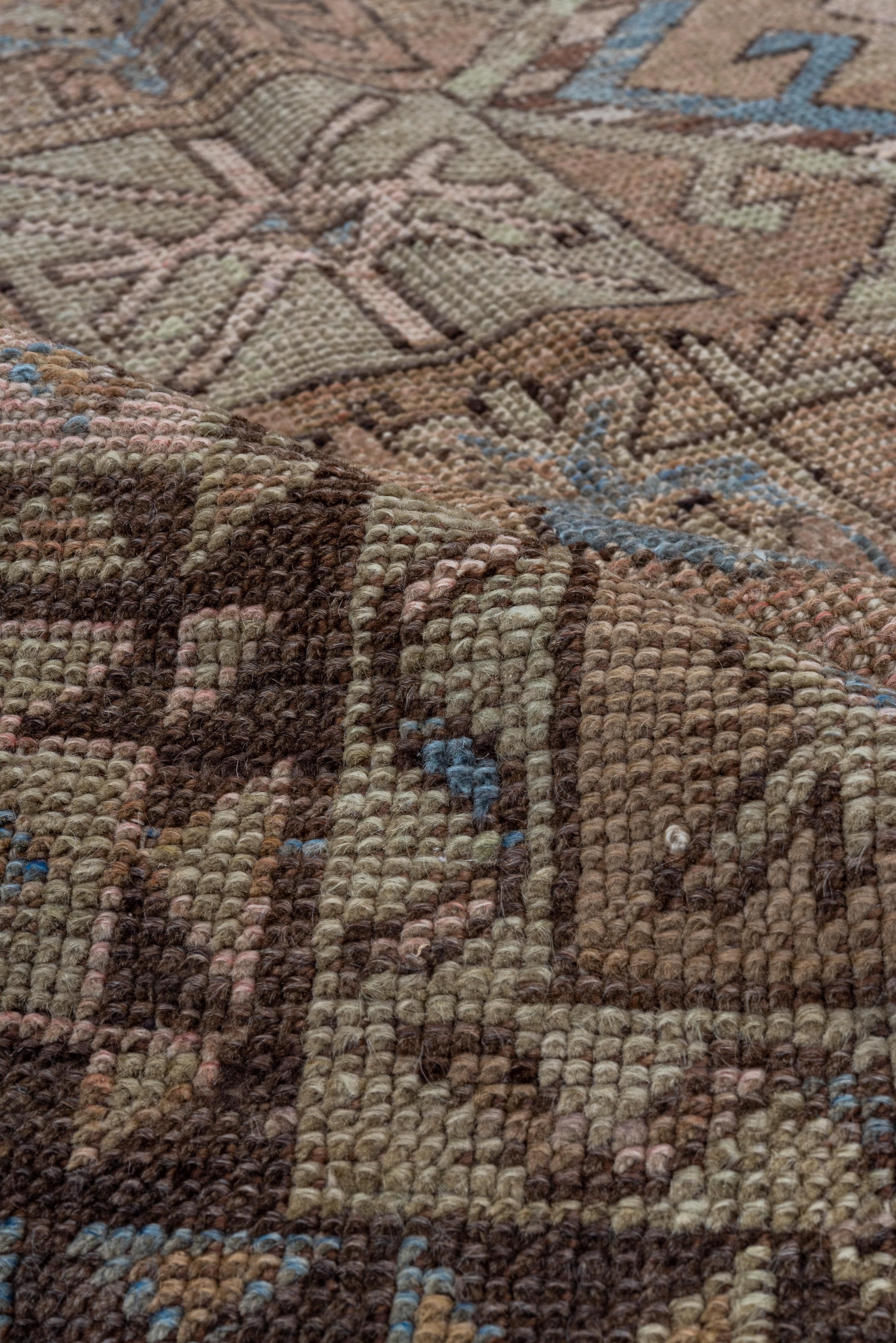 From around Konya in central Turkey, this subdued palette village kellegi (long rug) shows three connected octagons in buff on a soft brown ground,with light blue accents. Border abrashes tan to dark brown with a star-octagon pattern. Extra end