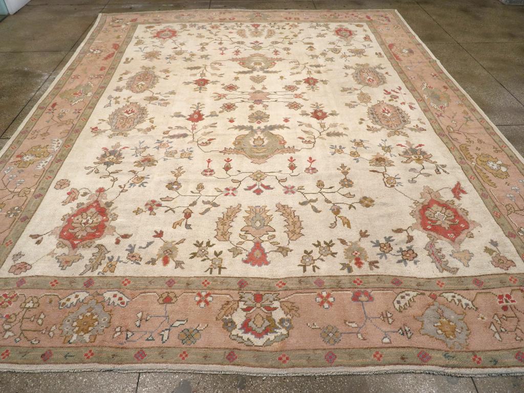 A wool pile of symmetric knots on a cotton foundation. This is a basically three-column design on an ecru-straw field, with oval rough palmettes and leafy palmettes, accompanied by flowers, thick lancet leaves and spindly flowering plants. Putty