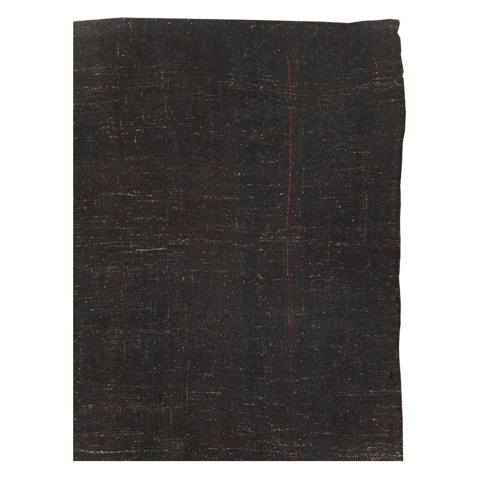 A vintage Turkish flat-weave Kilim room size carpet handmade during the mid-20th century with a Minimalist design over a dark brown and black field.

Measures: 9' 3
