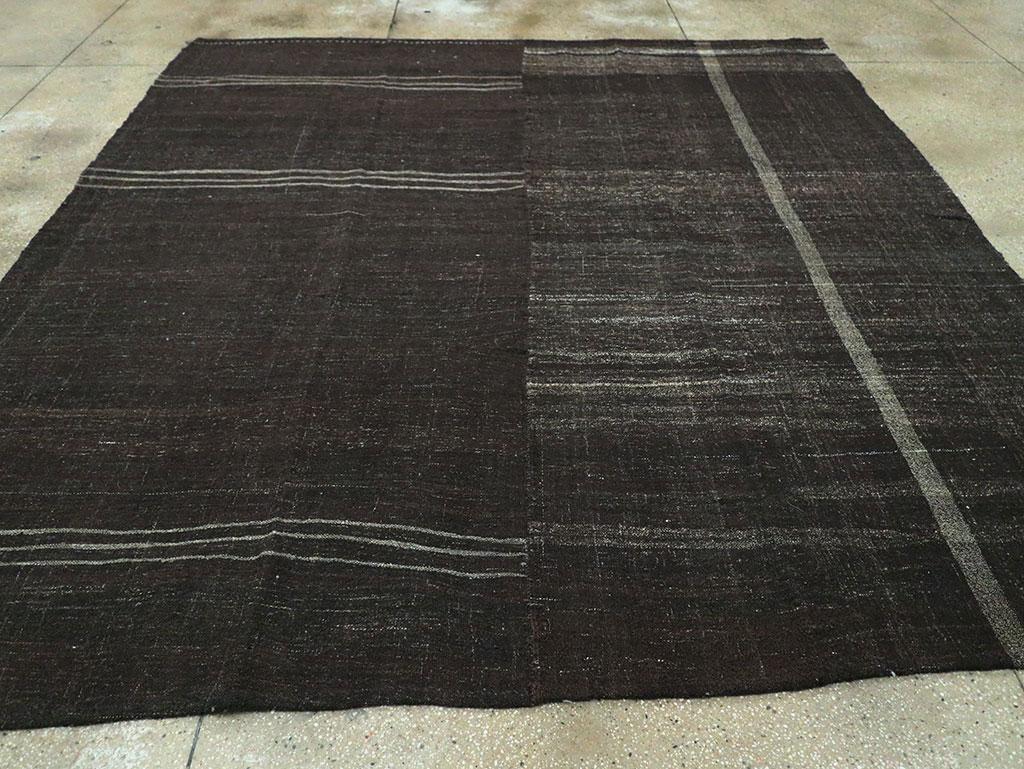 A vintage Turkish flat-weave Kilim square room size carpet handmade during the mid-20th century with a Minimalist design over a charcoal black field.

Measures: 10'0