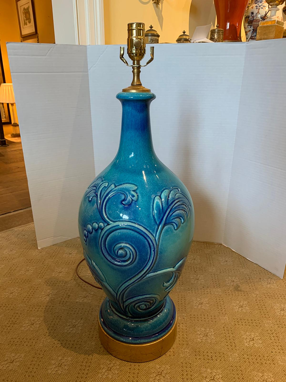 Mid-20th century turquoise pottery lamp with floral motif
New wiring.