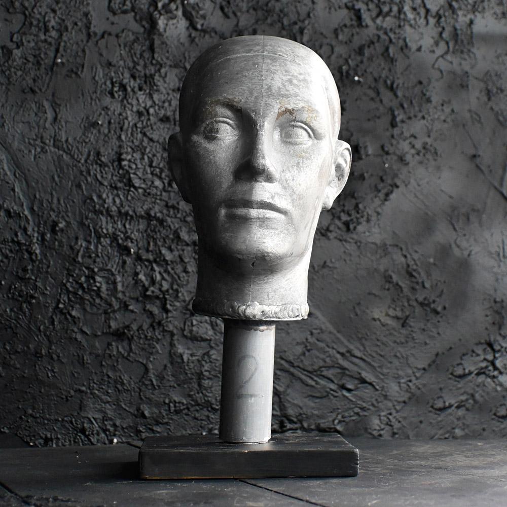 Mid-20th Century Unusual Mannequin Head Mold 
This unusual mid-20th century male form mannequin head mold is made from aluminium, in 2 bolted sections and displayed on a black wooden base. This item is untouched in form and very sculptural. 

Size