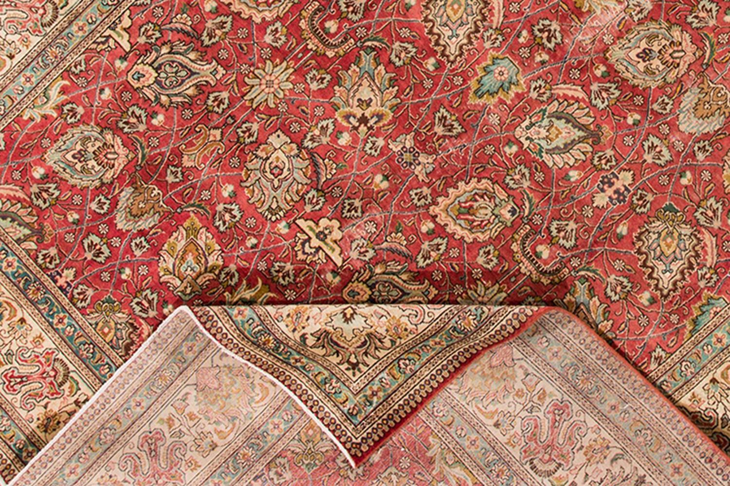 Beautiful vintage hand knotted Persian Tabriz rug with a rust field and floral motif. This piece has great detailing and a beautiful design. 

This rug measures 9' 5