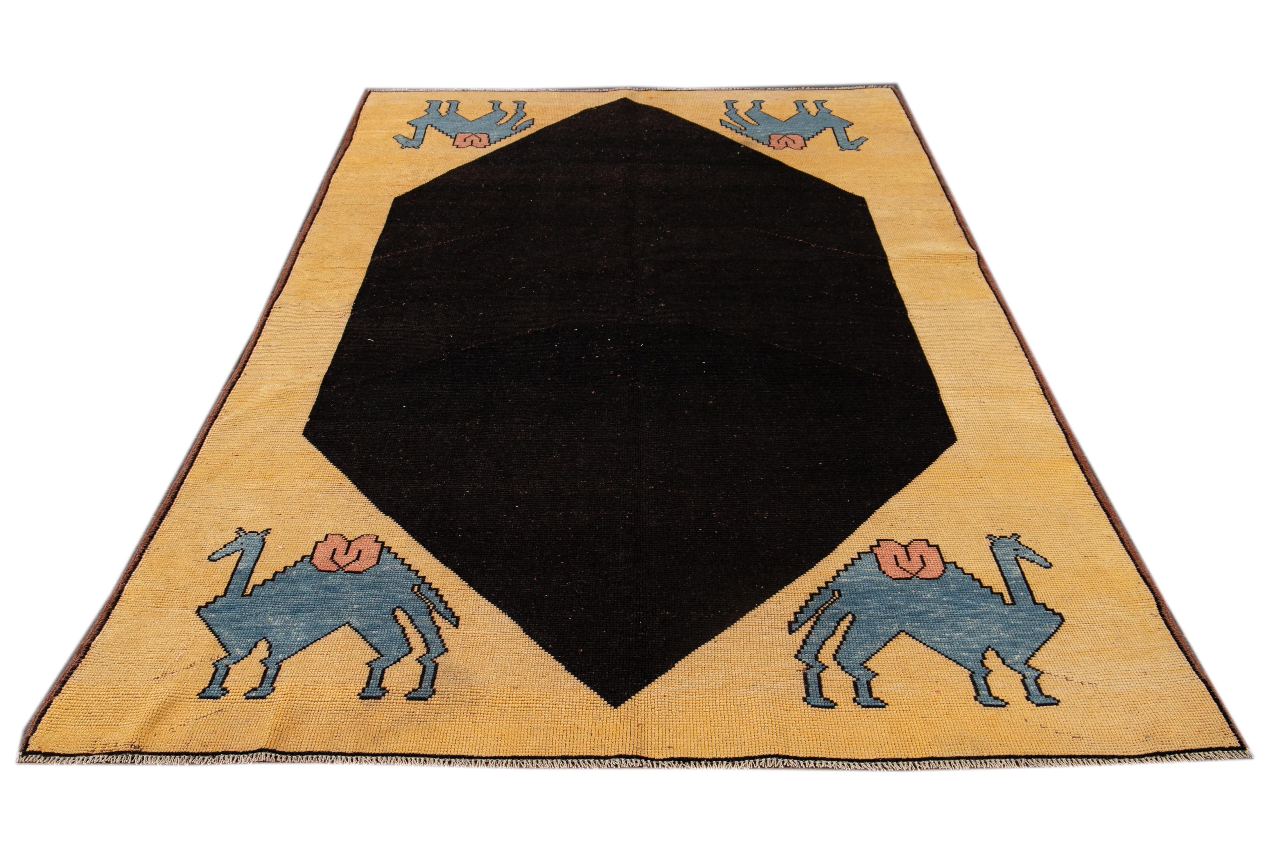 Beautiful vintage Turkish Art Deco rug, hand-knotted wool with a yellow field and black and blue accents in a gorgeous all-over geometric design,

This rug measures 6