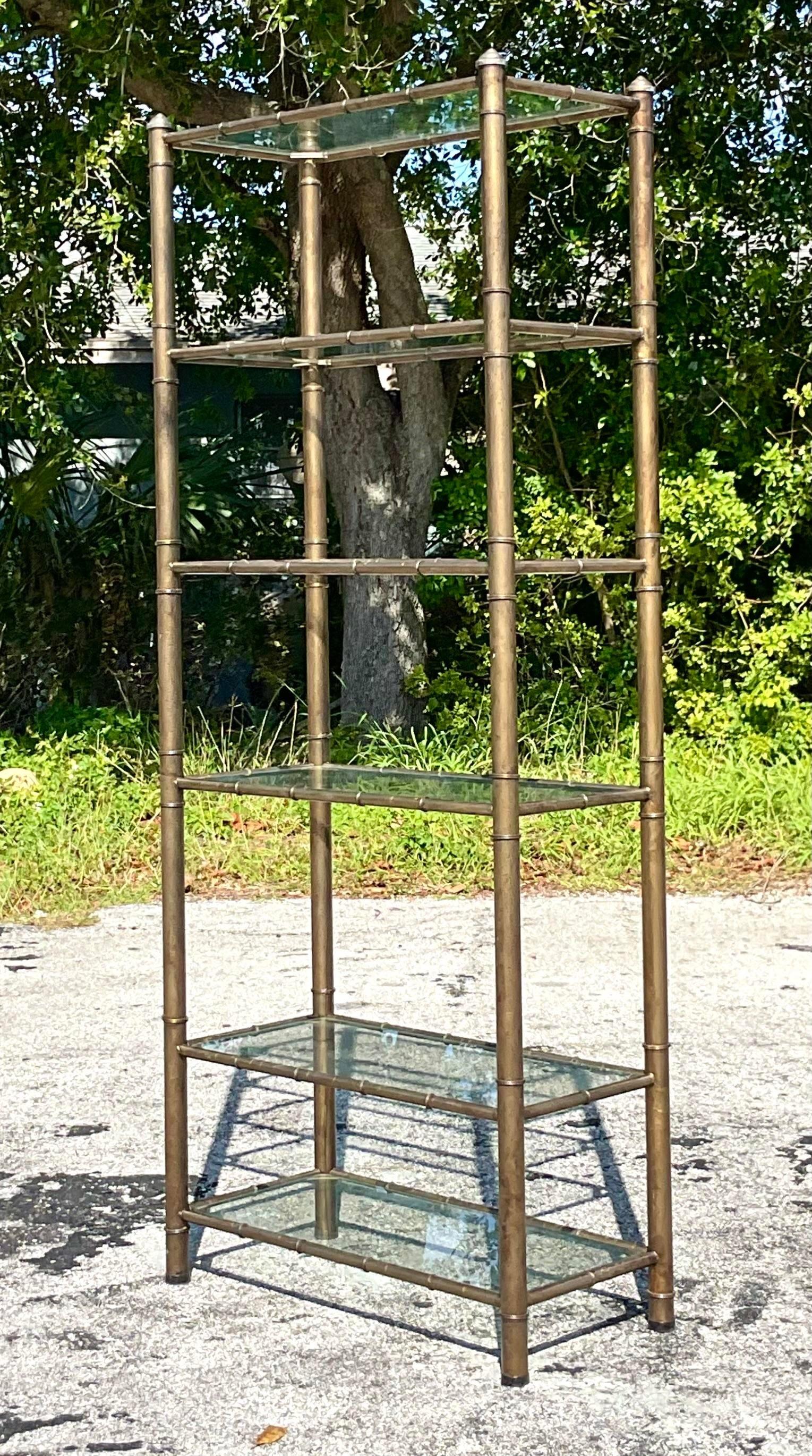 Elevate your space with vintage charm and American flair using this Vintage Boho Burnished Brass Etagere. Crafted with meticulous detail and timeless appeal, this etagere effortlessly blends Bohemian aesthetics with classic American design. Perfect