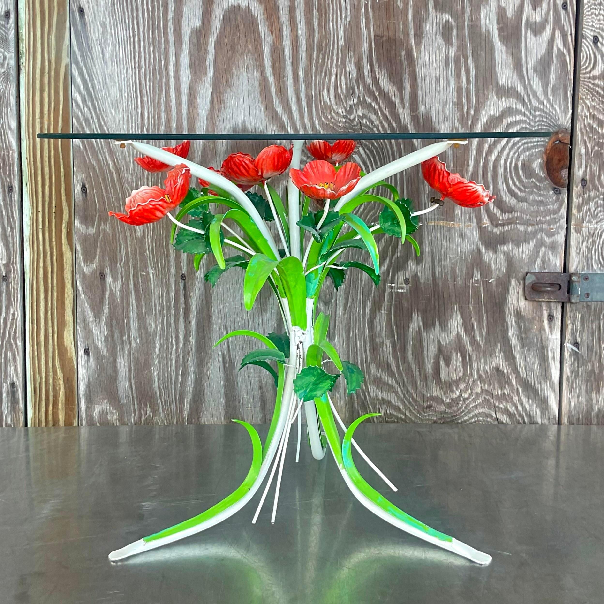 A vintage Boho Italian side table. A chic hand painted bouquet of bright red poppies. 24 inch round glass top rests on the surface. A cheerful addition to any space. Acquired from a Palm Beach estate