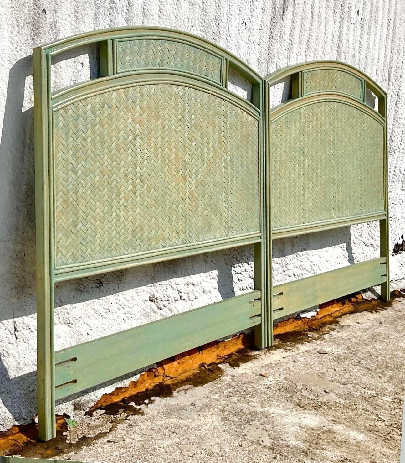 Vintage pair of twin rattan headboards that have chevron pattern with reed detailing around the edges. Fabulous Florida regency style rattan headboards that immediately add a sense worldly collection to a guest space. Of course can also be joined to