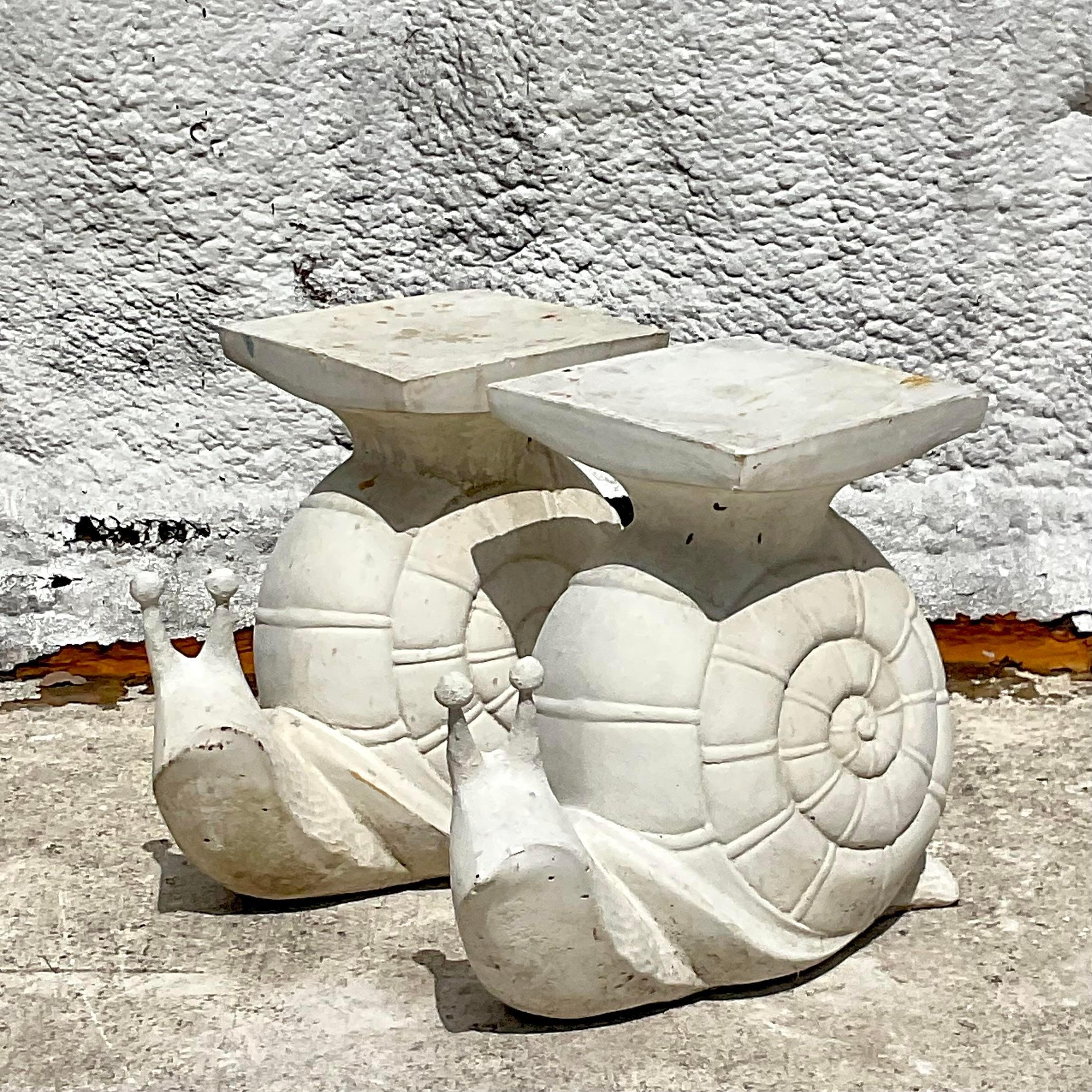 Embrace coastal whimsy with this delightful pair of Vintage Cast Cement Snail Low Stools, reminiscent of serene seaside charm. Crafted with durable cement and adorned with whimsical snail motifs, they effortlessly blend practicality with playful