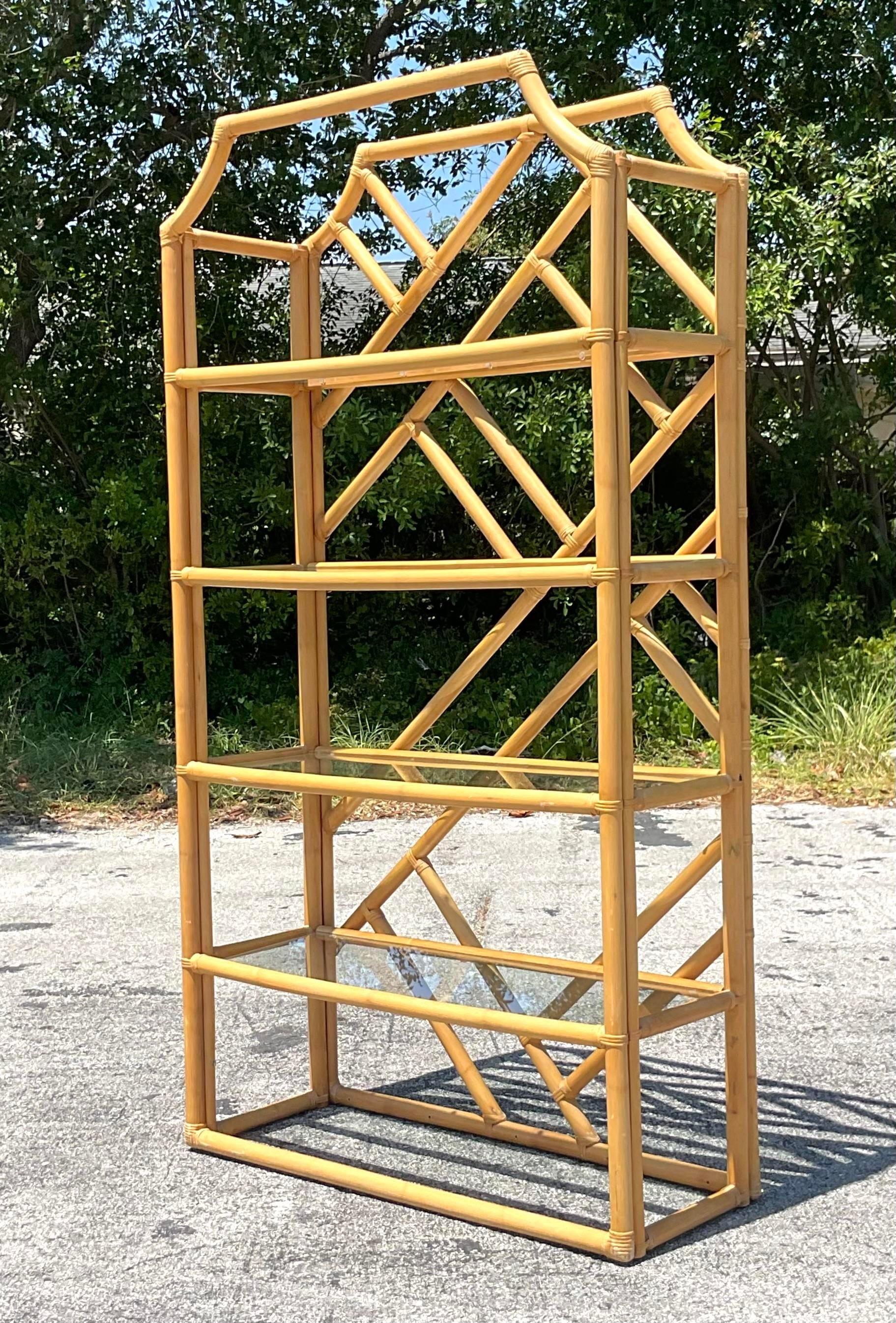 Showcase coastal elegance with our Vintage Coastal Chinese Chippendale Rattan Etagere. This stunning piece combines the intricate design of Chinese Chippendale with the natural appeal of rattan, capturing a blend of American sophistication and