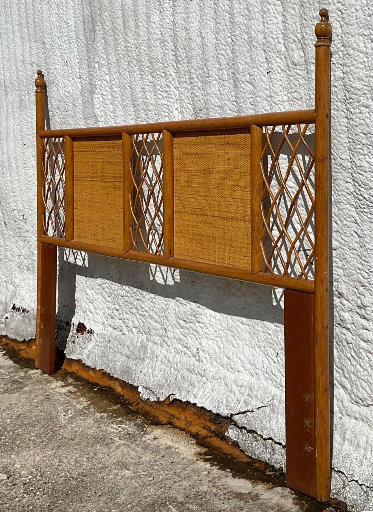 A fabulous vintage Coastal Queen headboard. A chic rattan poster frame with inset woven rattan panels. A chic trellis rattan design. Acquired from a Palm Beach estate.