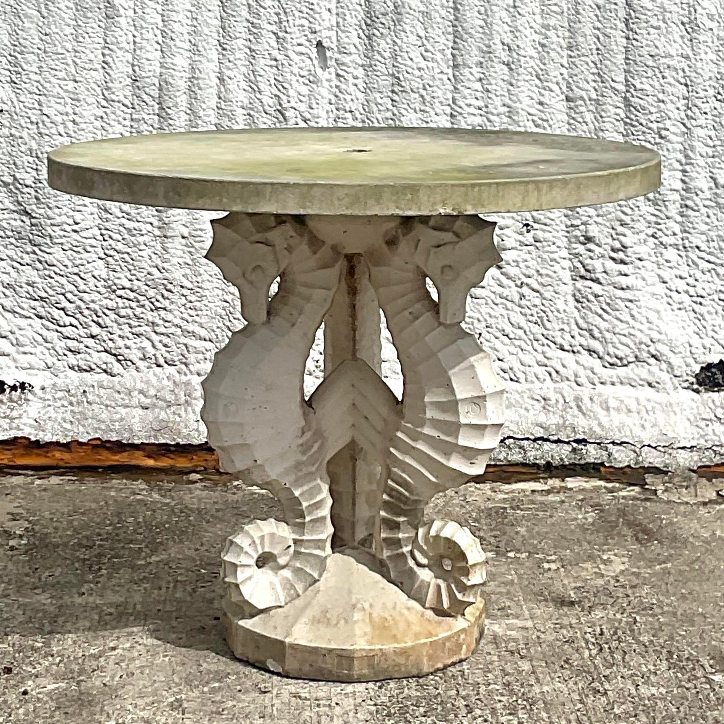 A spectacular vintage Coastal Center table. A chic trio of seashorses cast from cement. A cement top with a beautiful patina from time. Acquired from a Palm Beach estate. 