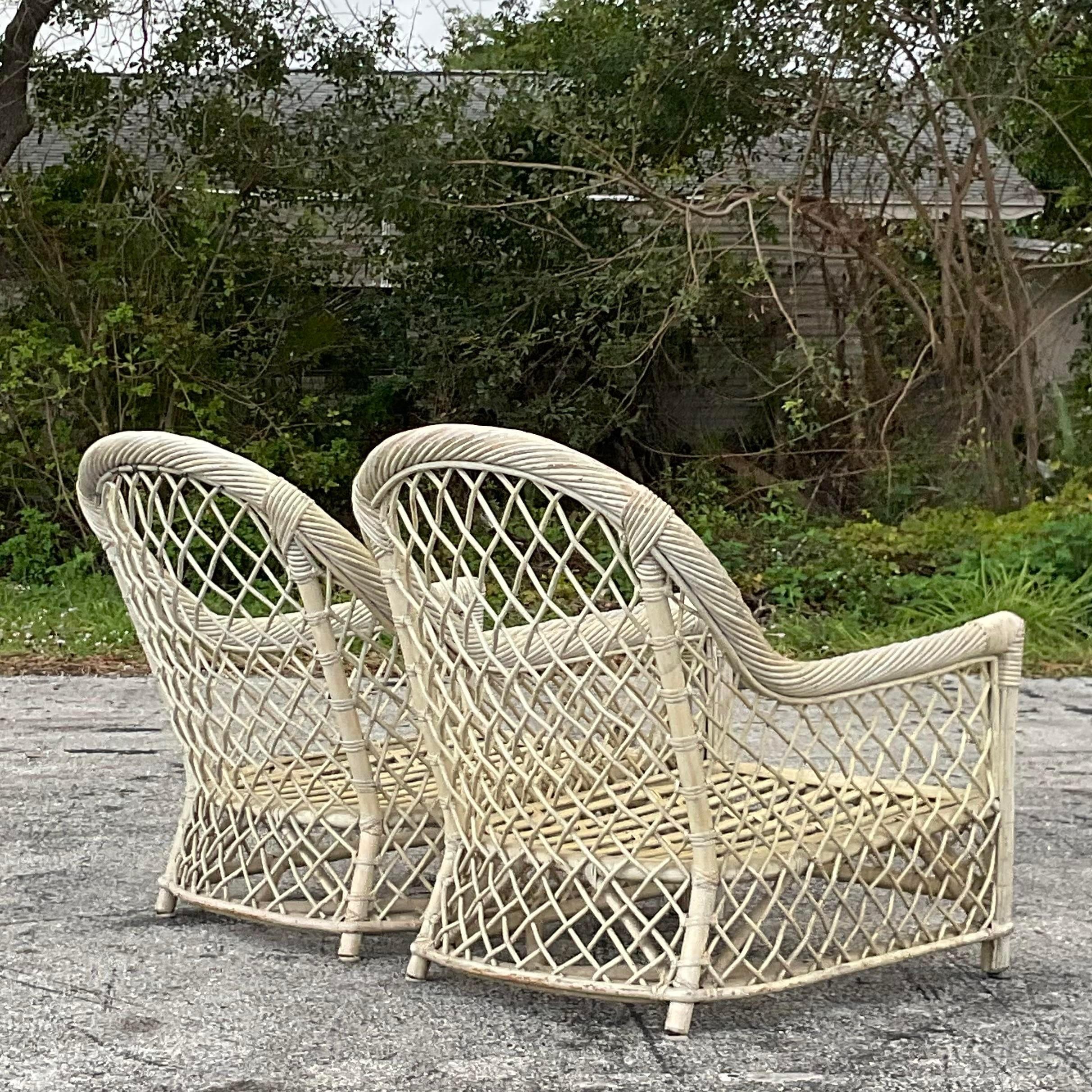 A fantastic pair of vintage Coastal Deauville lounge chairs. Chic trellis rattan in a pale sage green wash. Matching sofa also available on my page. Acquired from a Palm Beach estate.