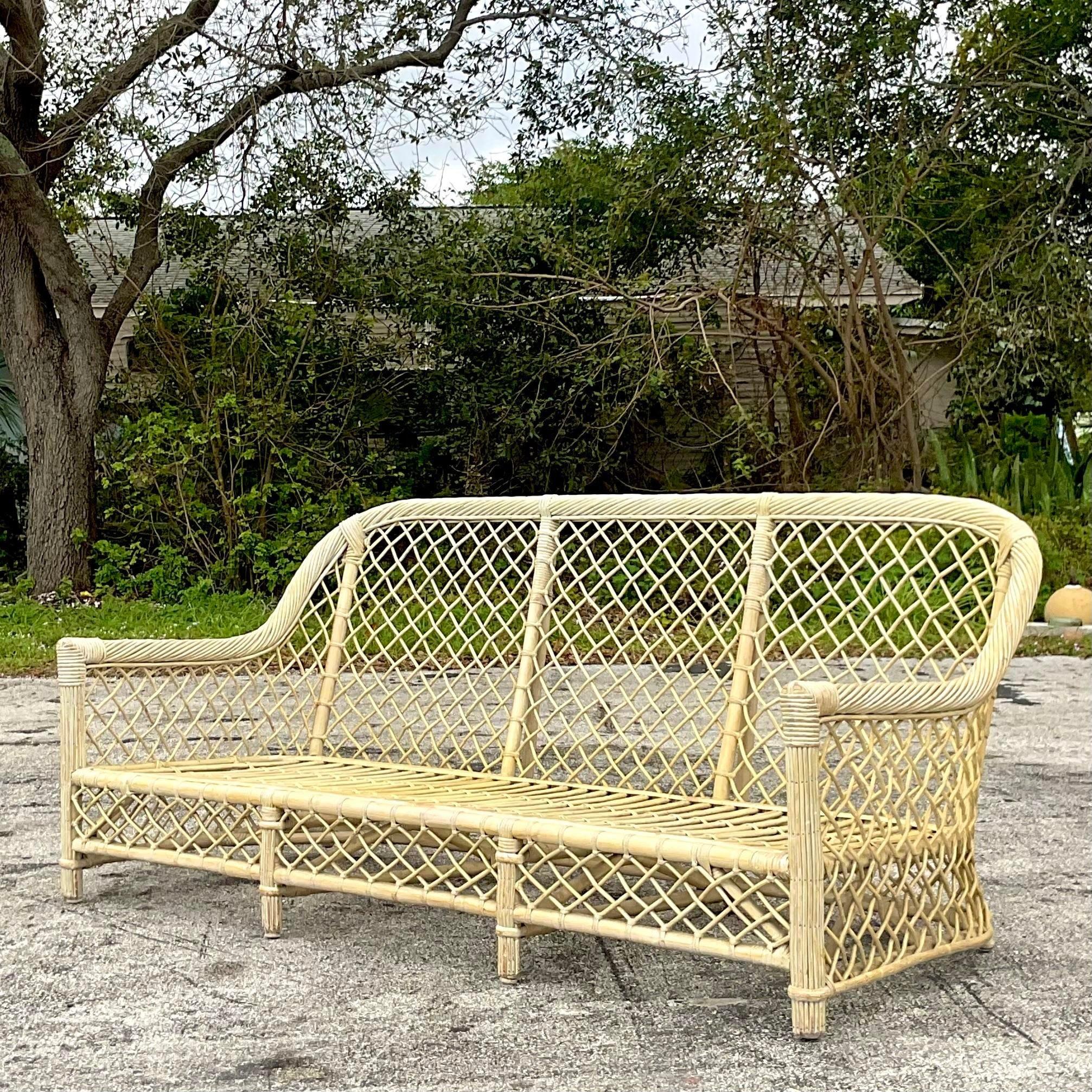  fantastic vintage Coastal sofa. A chic Deauville style trellis rattan in a pale green wash. Coordinating lounge chairs also available on my page. Acquired from a Palm Beach estate