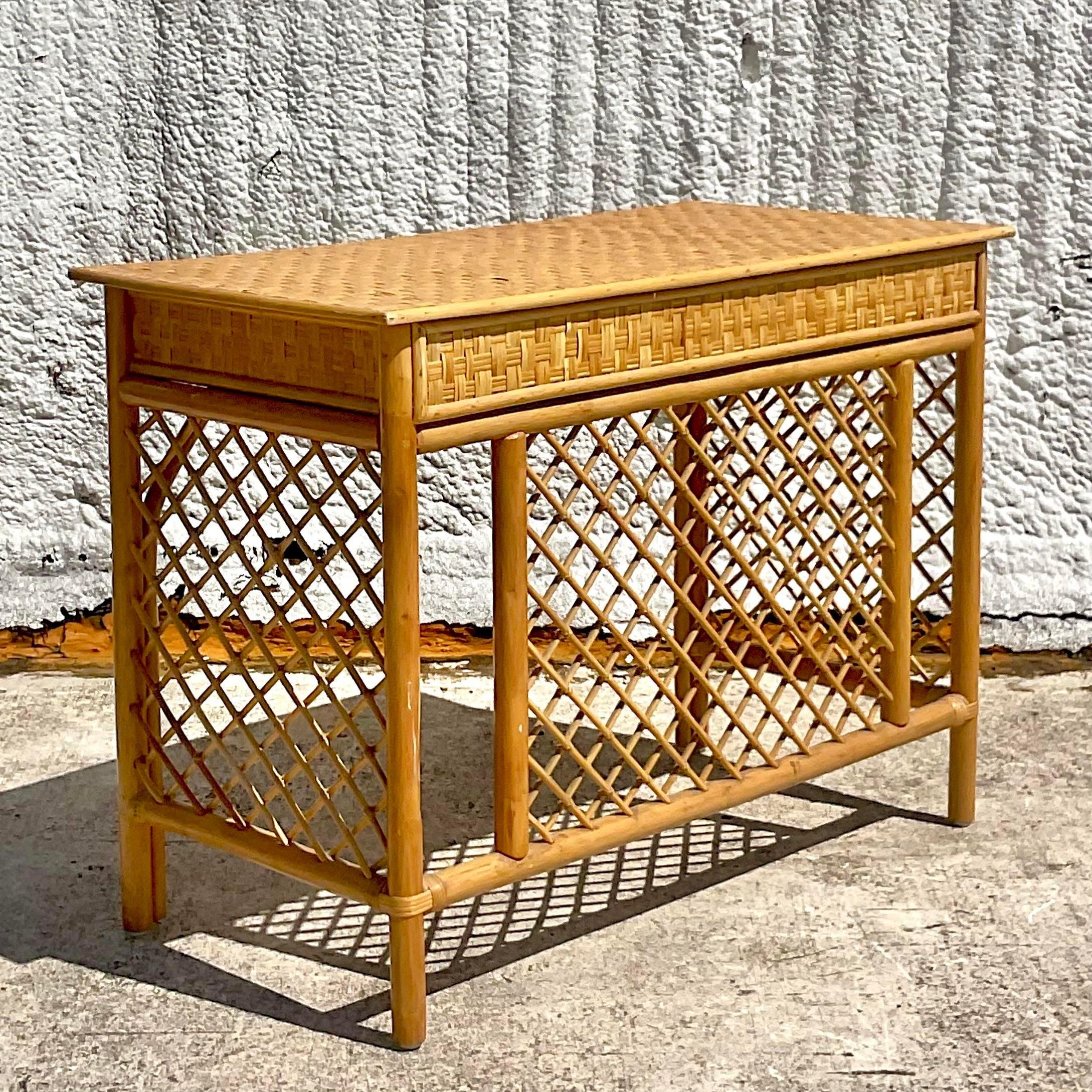 Immerse yourself in coastal tranquility with our Vintage Coastal Trellis Rattan Writing Desk. Handcrafted with meticulous detail and inspired by classic American design, this desk blends the natural allure of rattan with the timeless elegance of