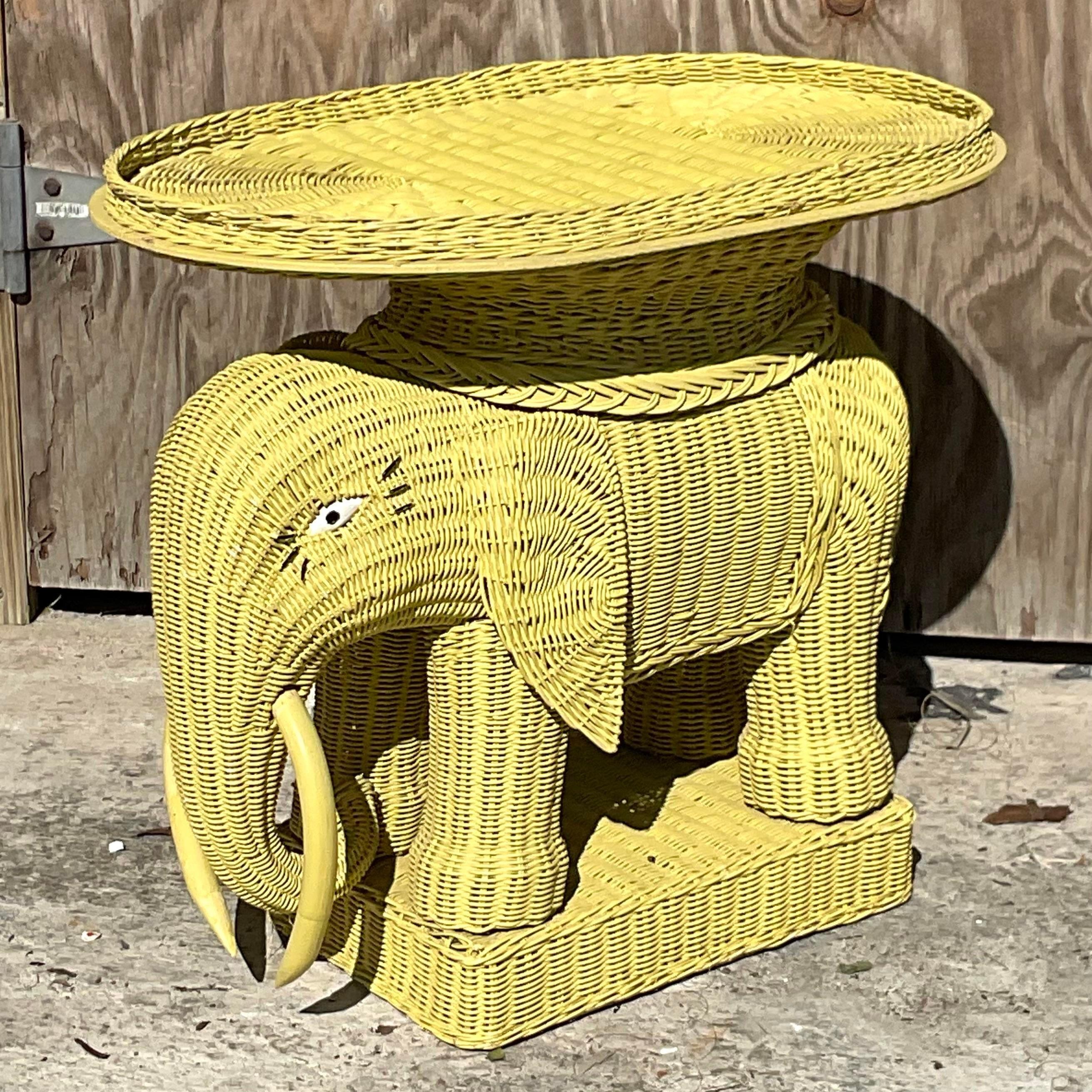 A fabulous vintage Coastal drinks table. A classic woven rattan elephant with a removable tray on top. Painted a brilliant green with a charming set of eyelashes. Acquired from a Palm Beach estate.