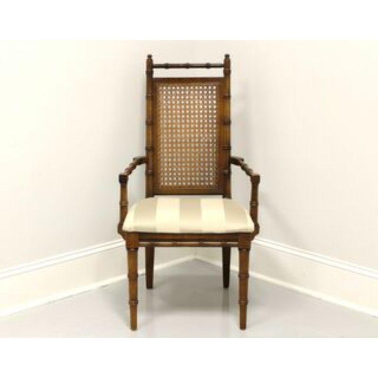 A Chinoiserie style armchair by the American Furniture Company, of Chilhowie, Virginia, USA. Faux bamboo frame with caned seatback and neutral color stripe upholstered seat. Made in the mid 20th Century.

Measures: Overall: 22.5W 26D 40.25H, Seat:
