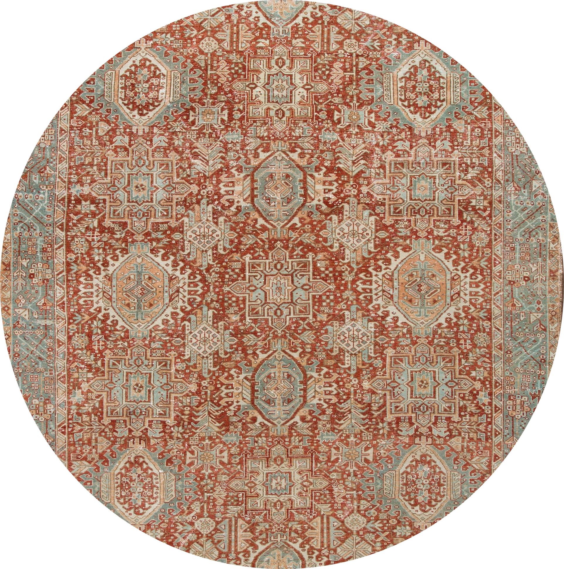 Beautiful 20th-century vintage Heriz wool rug with a rust field, ivory, blue, and peach accents in the all-over multi-medallion design.

This rug measures: 7'9” x 11'.