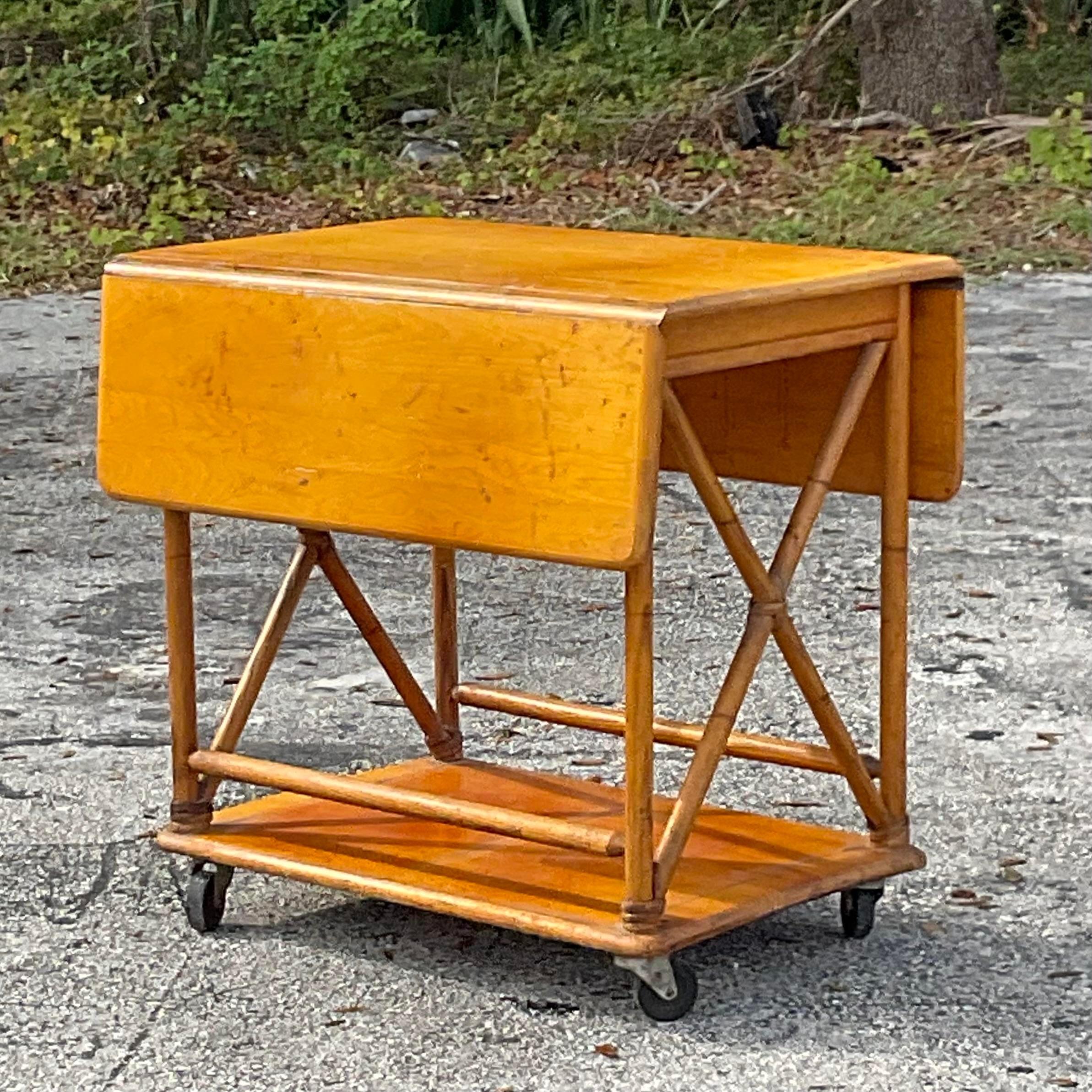 A fabulous vintage MCM bar cart. Made by the iconic Heywood Wakefield and tagged on the bottom. Two drop leaf panels for extended surface area. Acquired from a Palm Beach estate.

36.75 extended top