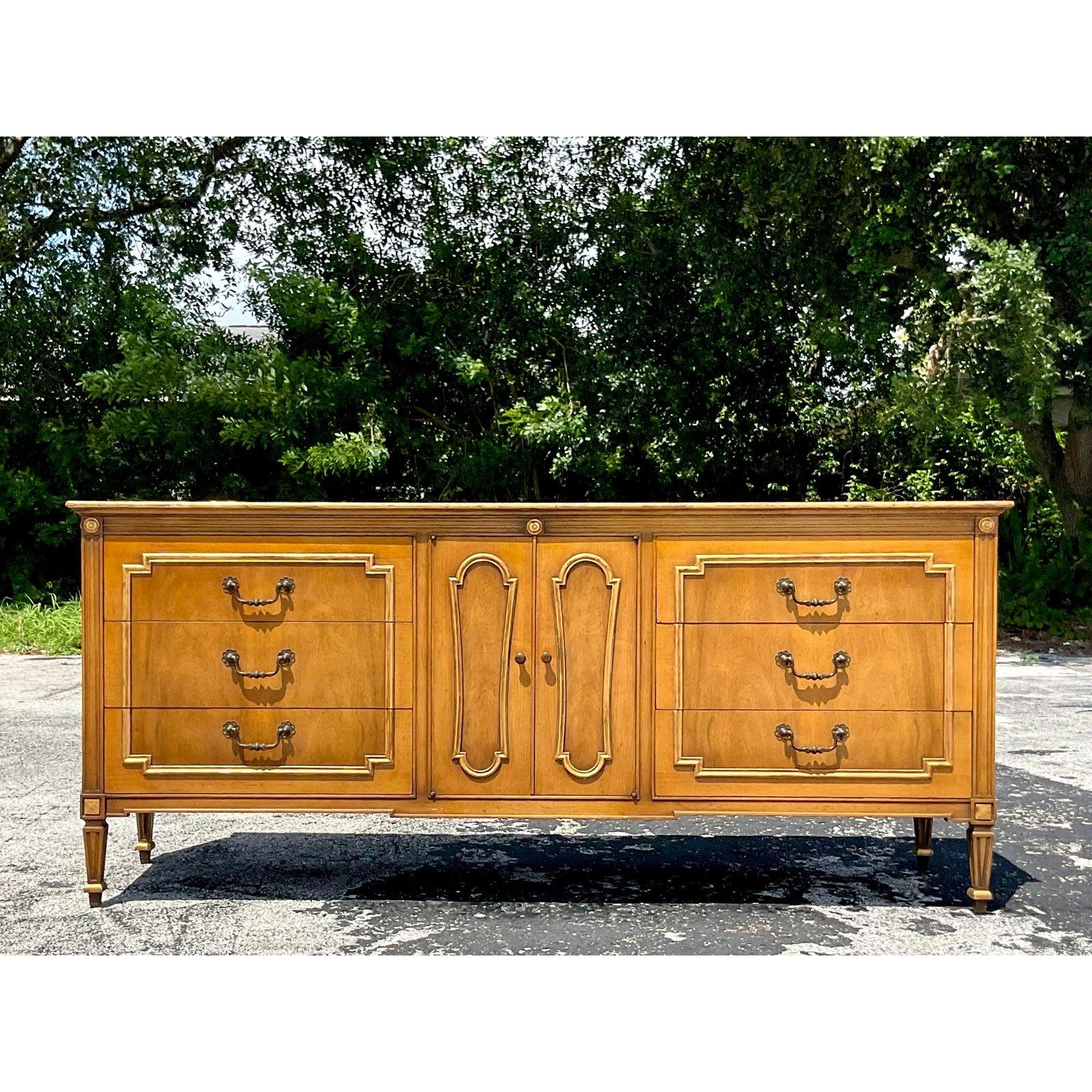 A sensational vintage MCM credenza. Made by the iconic John Widdicomb and tagged inside the drawer. Gorgeous gilt tipped detail and brass hardware. Acquired from a Palm Beach estate