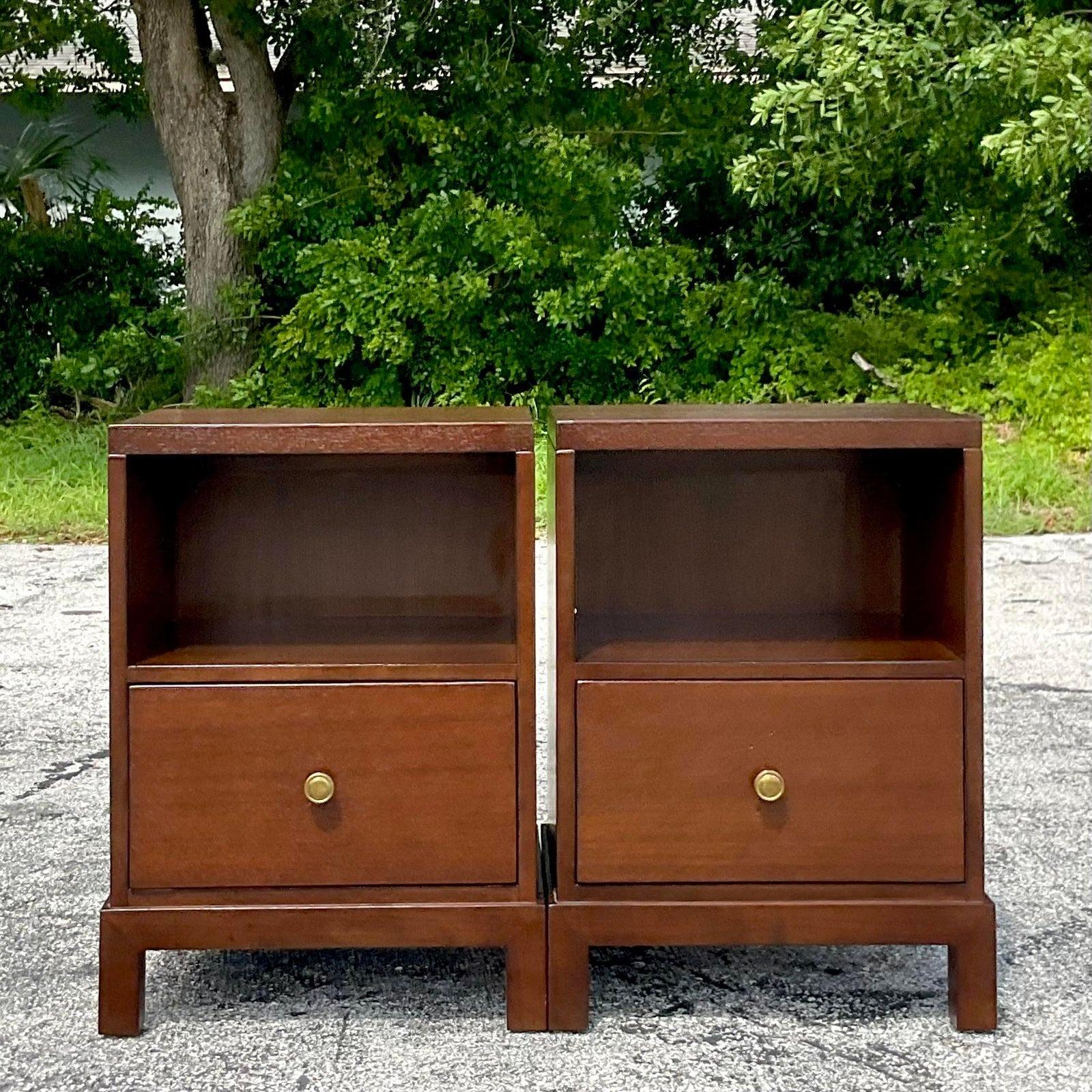 A fabulous pair of vintage MCM nightstands. Chic warm wood with brass hardware. Made by the iconic John a Widdicomb group and tagged inside the drawer. Acquired from a Palm Beach estate.