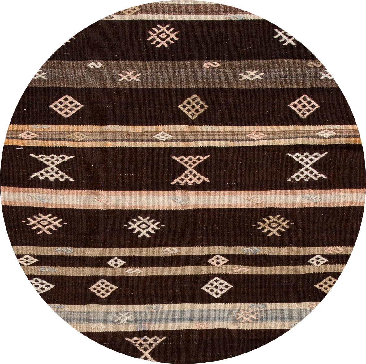 A beautiful vintage kilim runner with an all-over brown motif. This piece has fine details, great colors, and beautiful stripe design. It would be the perfect addition to your home. 


This rug measures 3'4