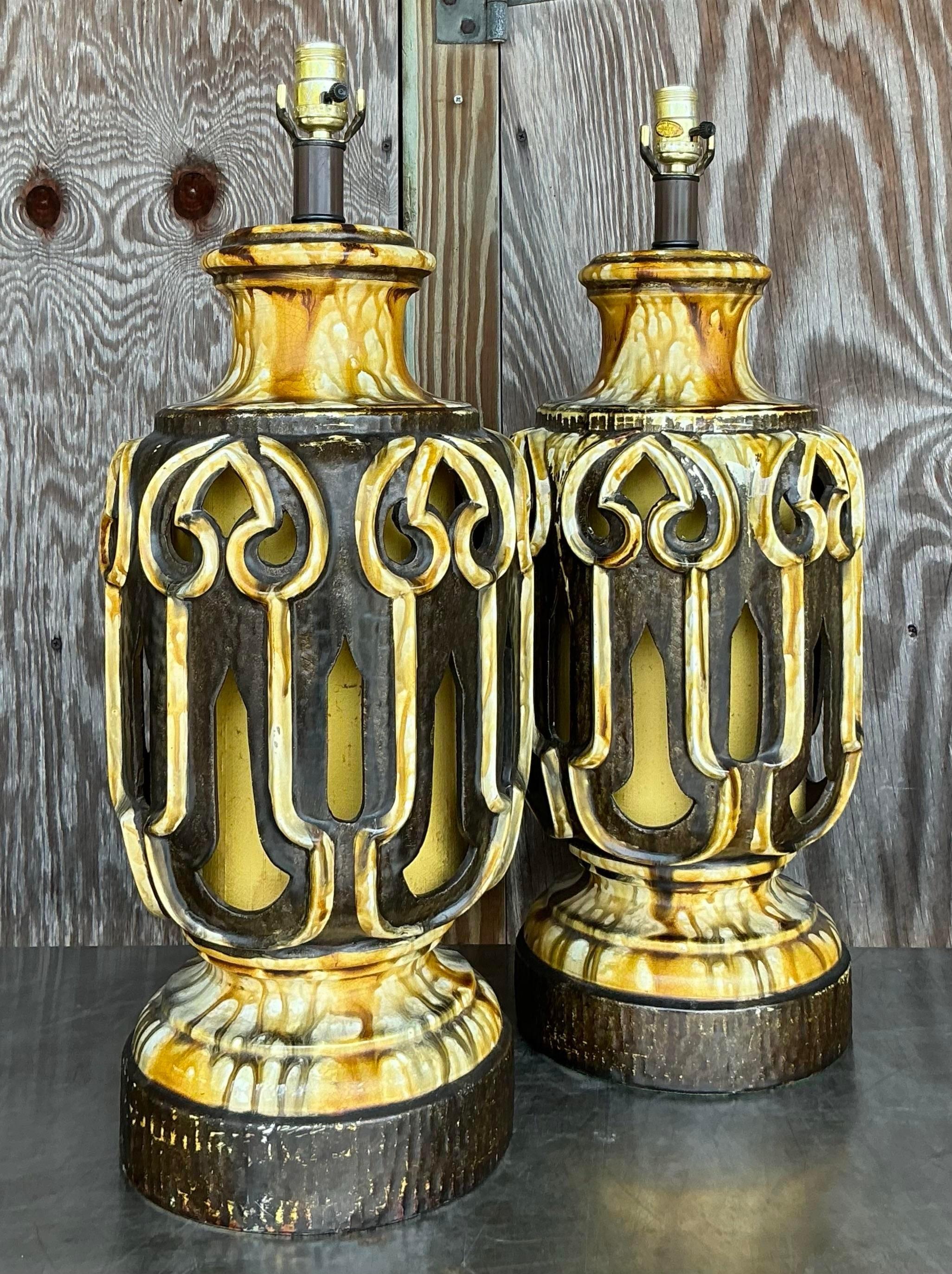 Add a touch of classic American style to your home with this pair of Vintage MCM Glazed Ceramic Lamps. Exemplifying the elegance and innovation of Mid-Century Modern design, these lamps feature beautifully glazed ceramic bases that radiate a warm,