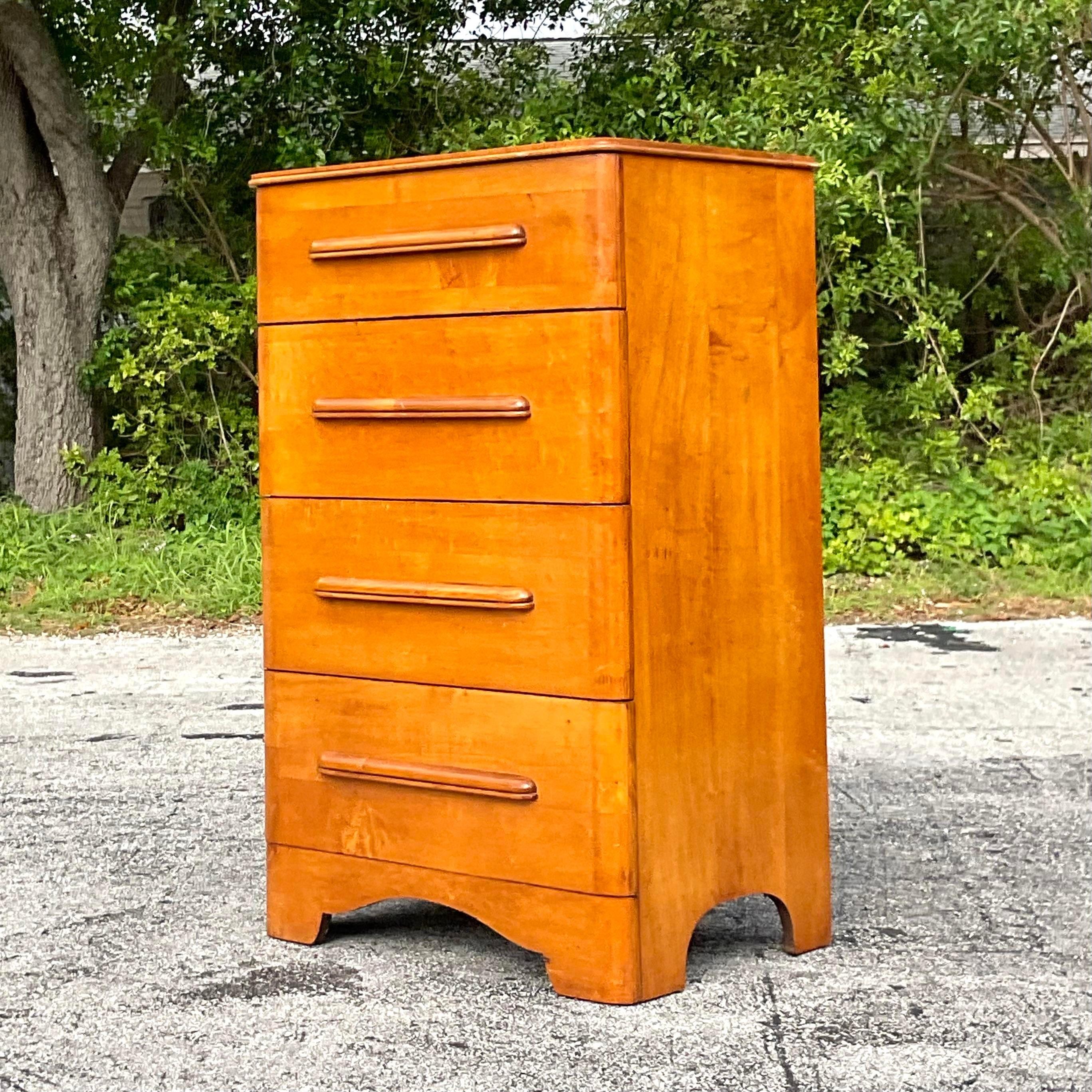 Elevate your storage solutions with this Vintage MCM Maple Tall Chest of Drawers. Crafted with timeless American Mid-Century Modern design, its sleek lines and warm maple wood evoke both functionality and style, offering a sophisticated addition to