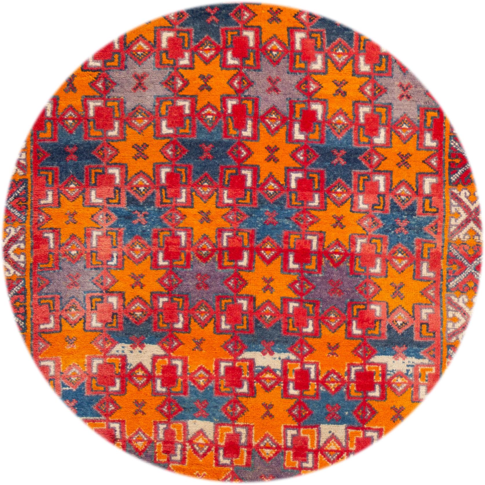 Beautiful vintage Moroccan rug, hand knotted wool with a red field, blue and orange accents in an all-over geometric design,
circa 1940.
This rug measures 4' 10
