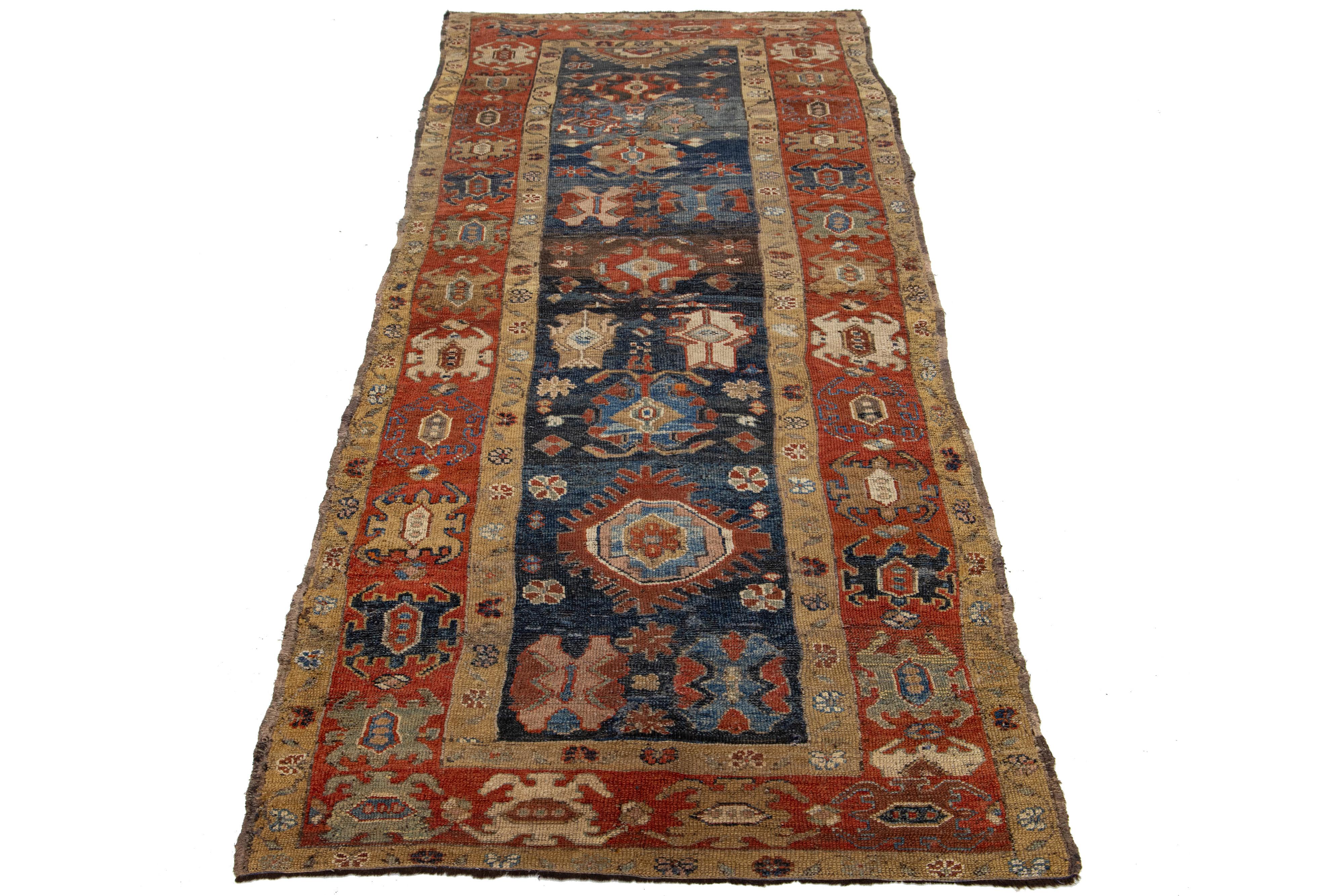 Chemin de table vintage persan Bakshaish noué à la main avec un champ bleu marine, un cadre de couleur rouille et des accents beiges dans un motif tribal all-over. Cette pièce présente de fins détails, de superbes couleurs et un beau design.

Ce