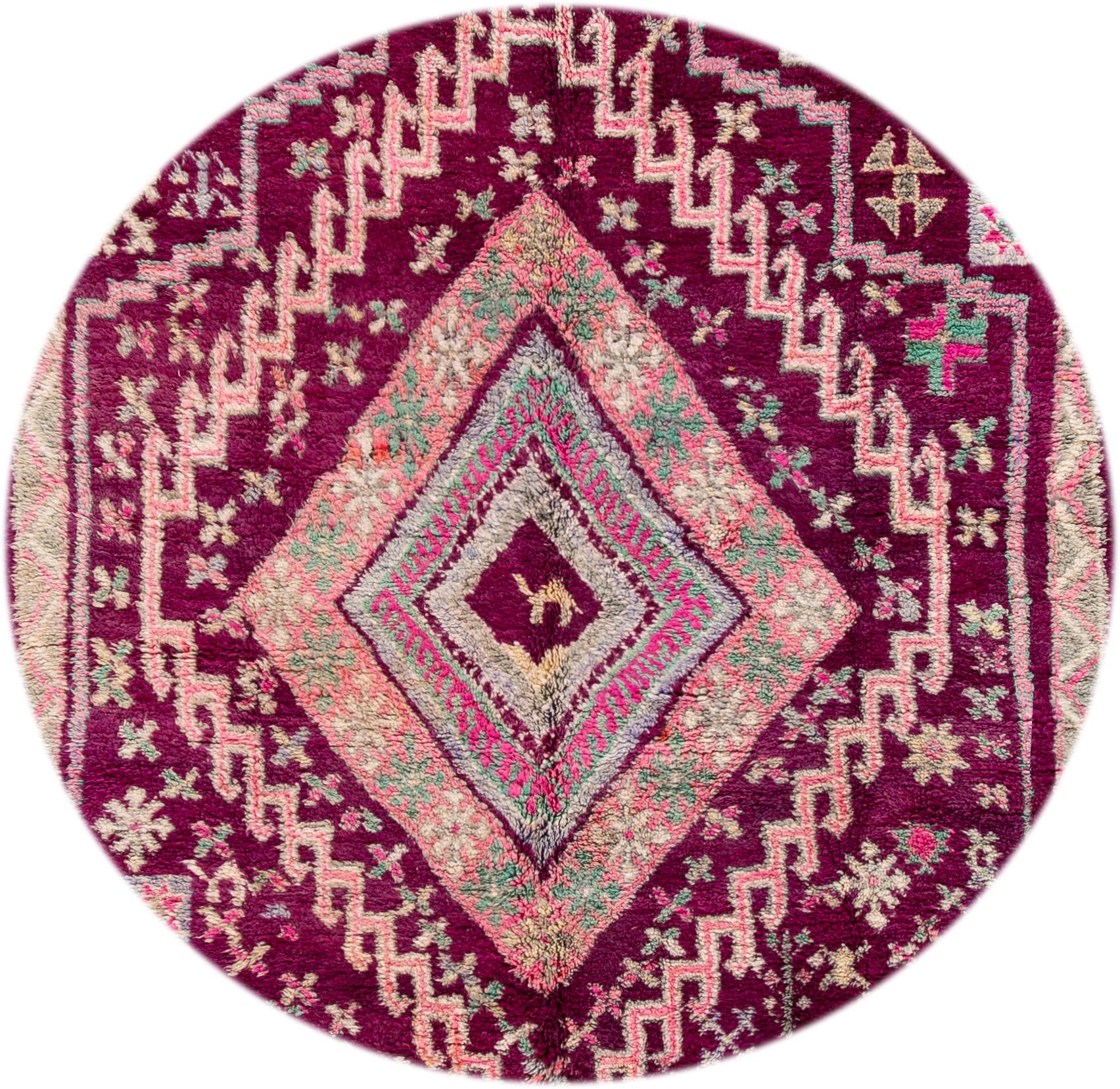 Beautiful hand knotted vintage tribal wool rug. This rug has a purple field with various pink and green accents, circa 1970.

This rug measures 6'6