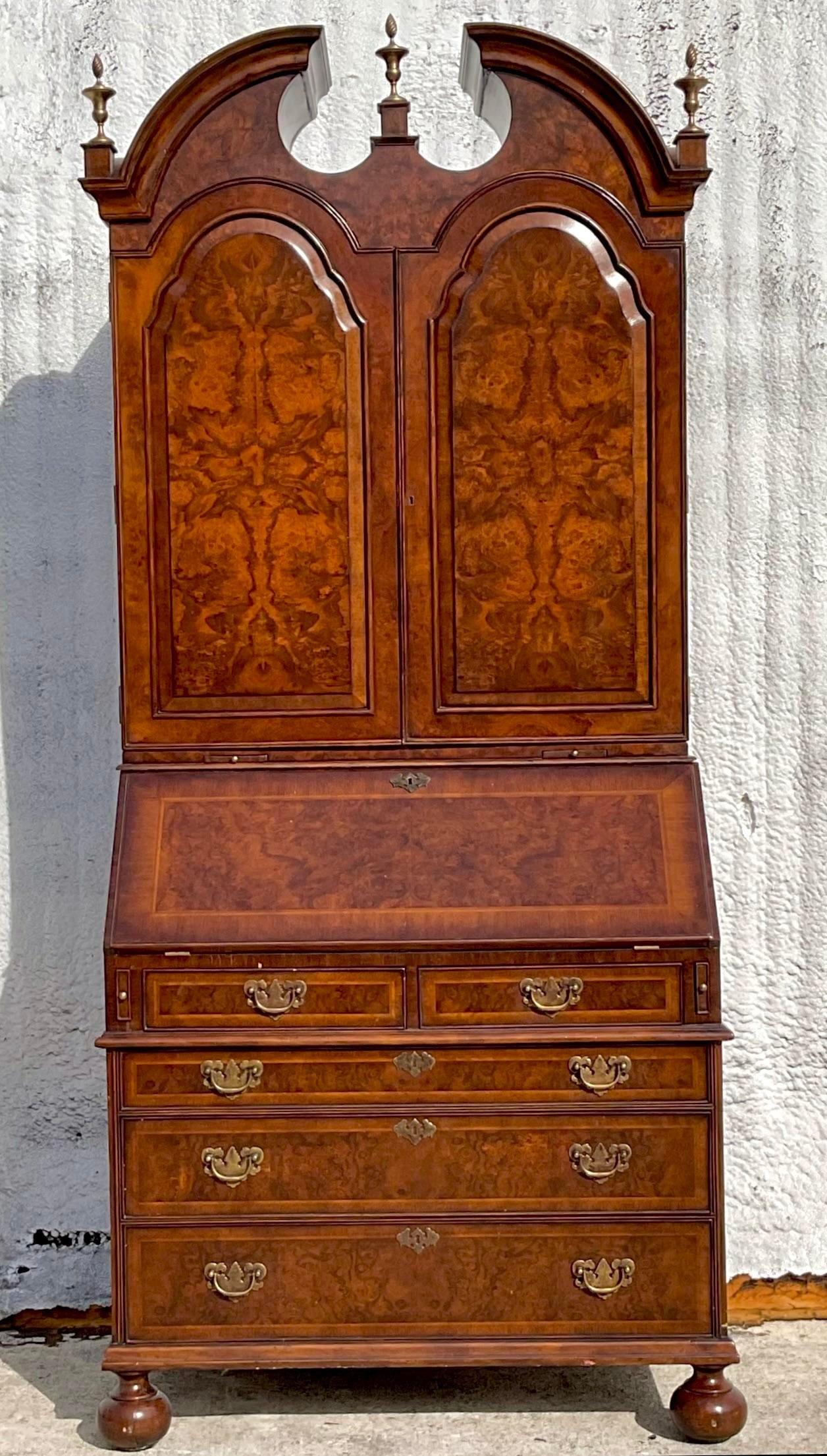 A stunning vintage Regency Secretary desk. Gorgeous Burl wood detail with incredible attention to detail. An amazing array of interior shelves and cabinets. Acquired from a Palm Beach estate.