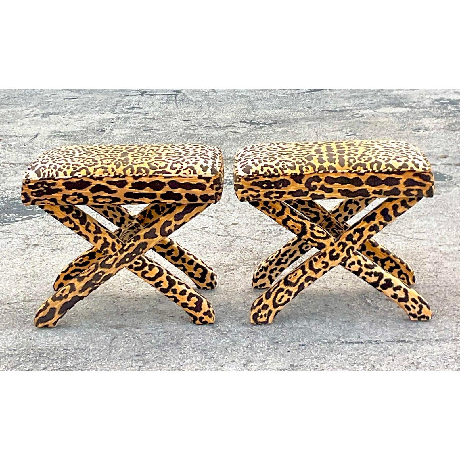 Introduce bold elegance to your space with this pair of Vintage Regency Leopard X Benches. These striking pieces combine American style with Regency flair, featuring plush leopard print upholstery and classic X-frame design. Perfect for adding a