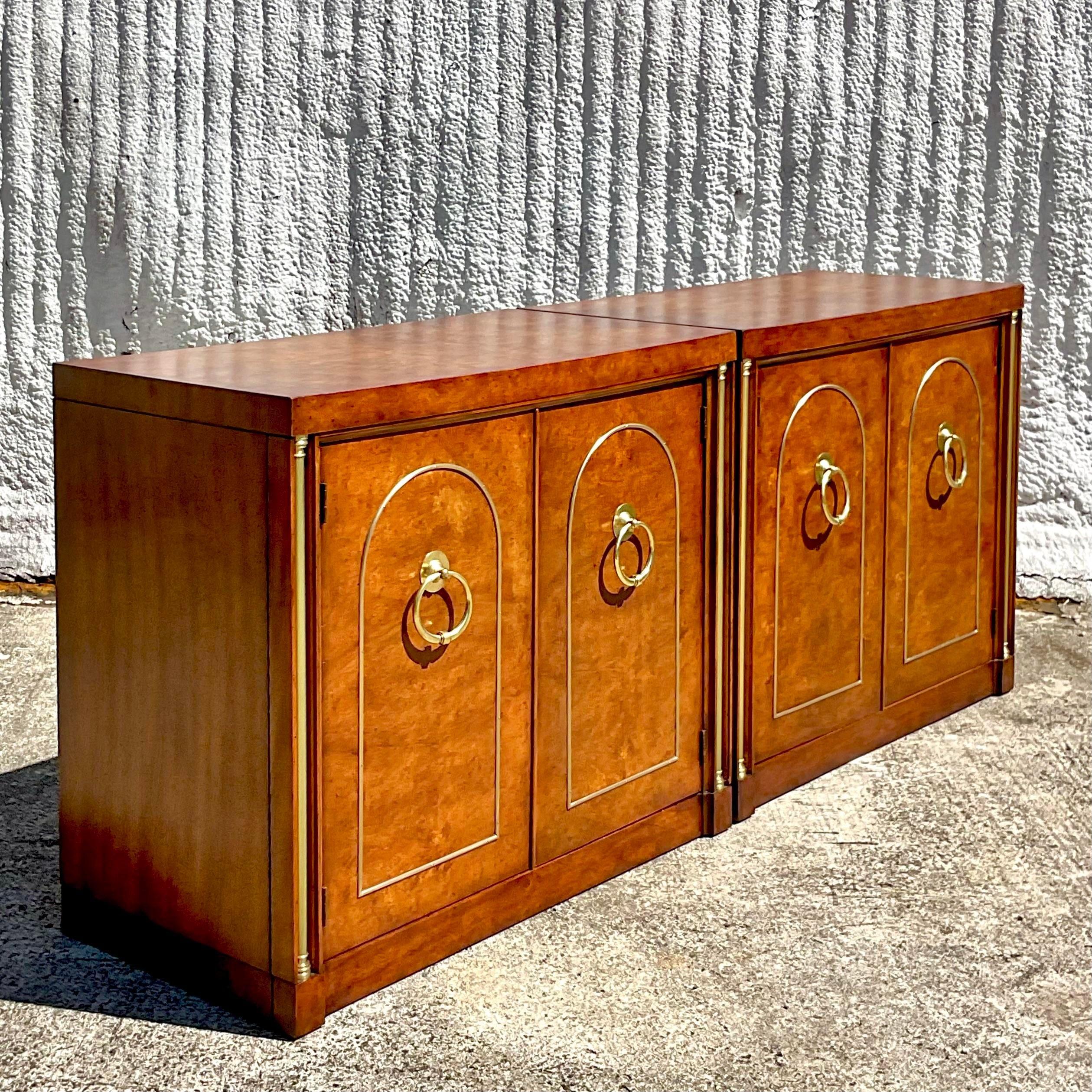 An exceptional pair of vintage Regency cabinets. Made by the iconic Weiman group and tagged inside the interior drawer. Beautiful Burl wood frame with incredible brass hardware. Acquired from a Palm Beach estate.